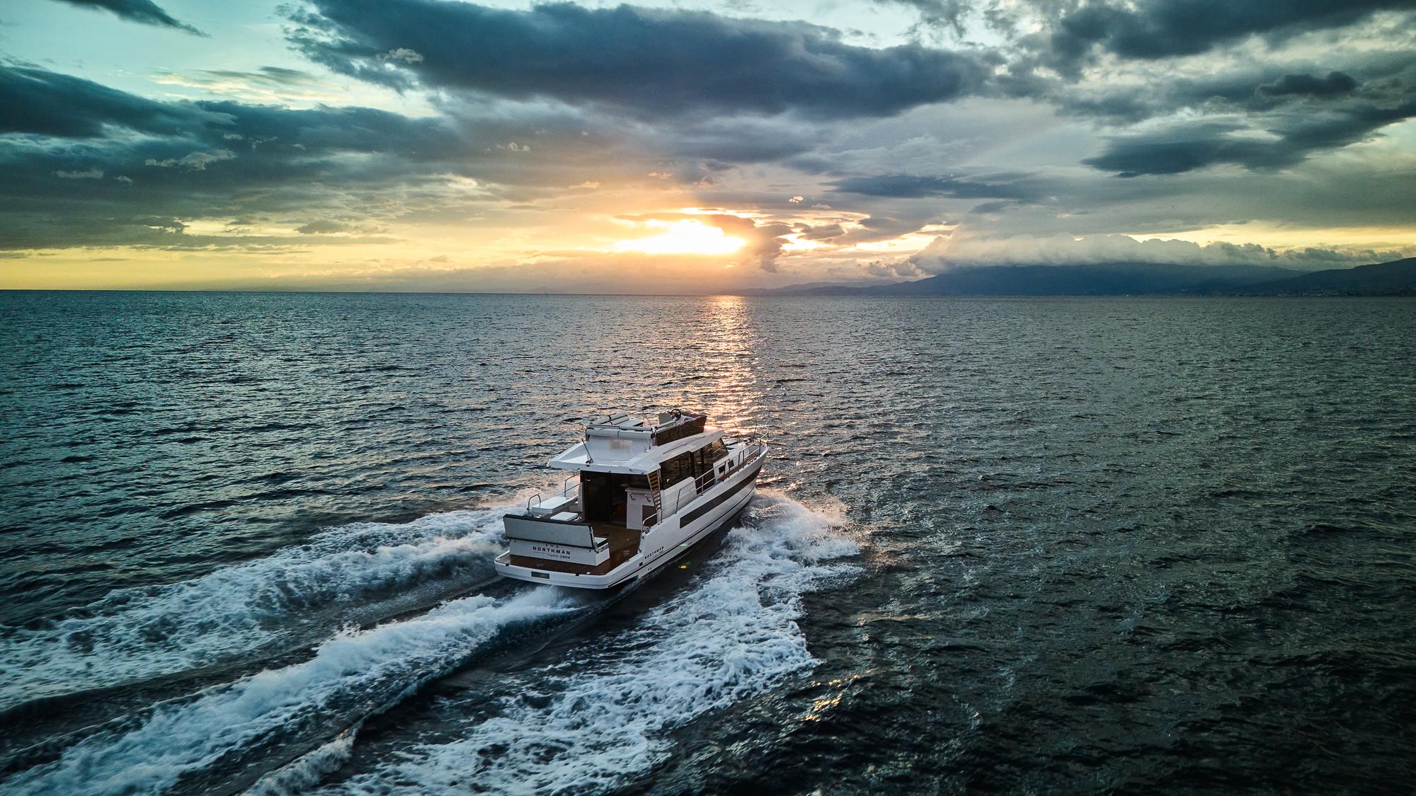Northman 1300 yacht cruising at sunset, 2025 model, on open sea.