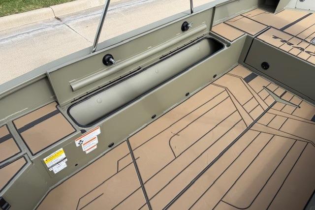 2026 Tracker Grizzly 1756 T Marsh boat interior with storage compartments and non-slip flooring.