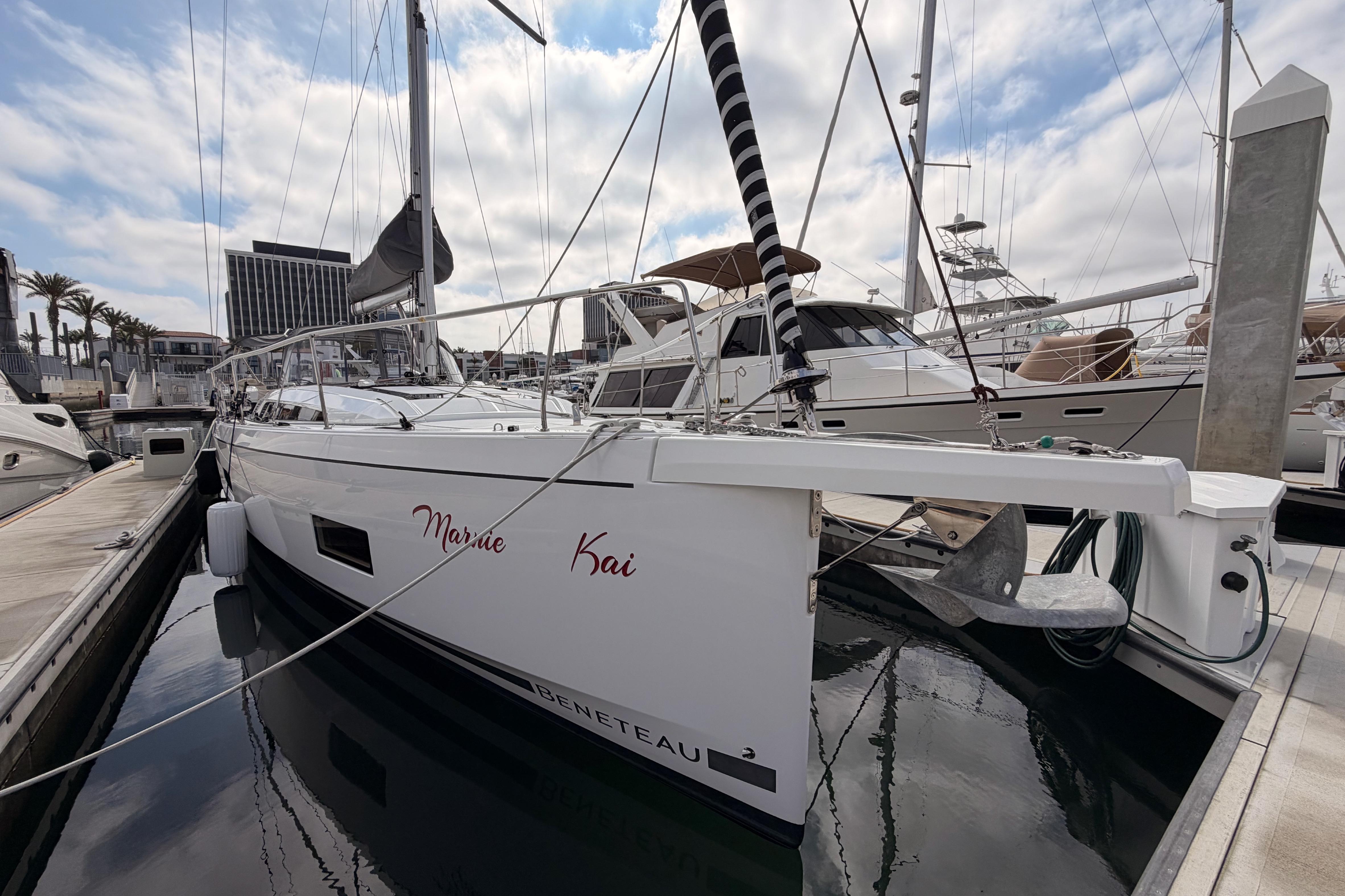 2020 Beneteau Oceanis 46.1 sailboat docked at marina under cloudy sky.