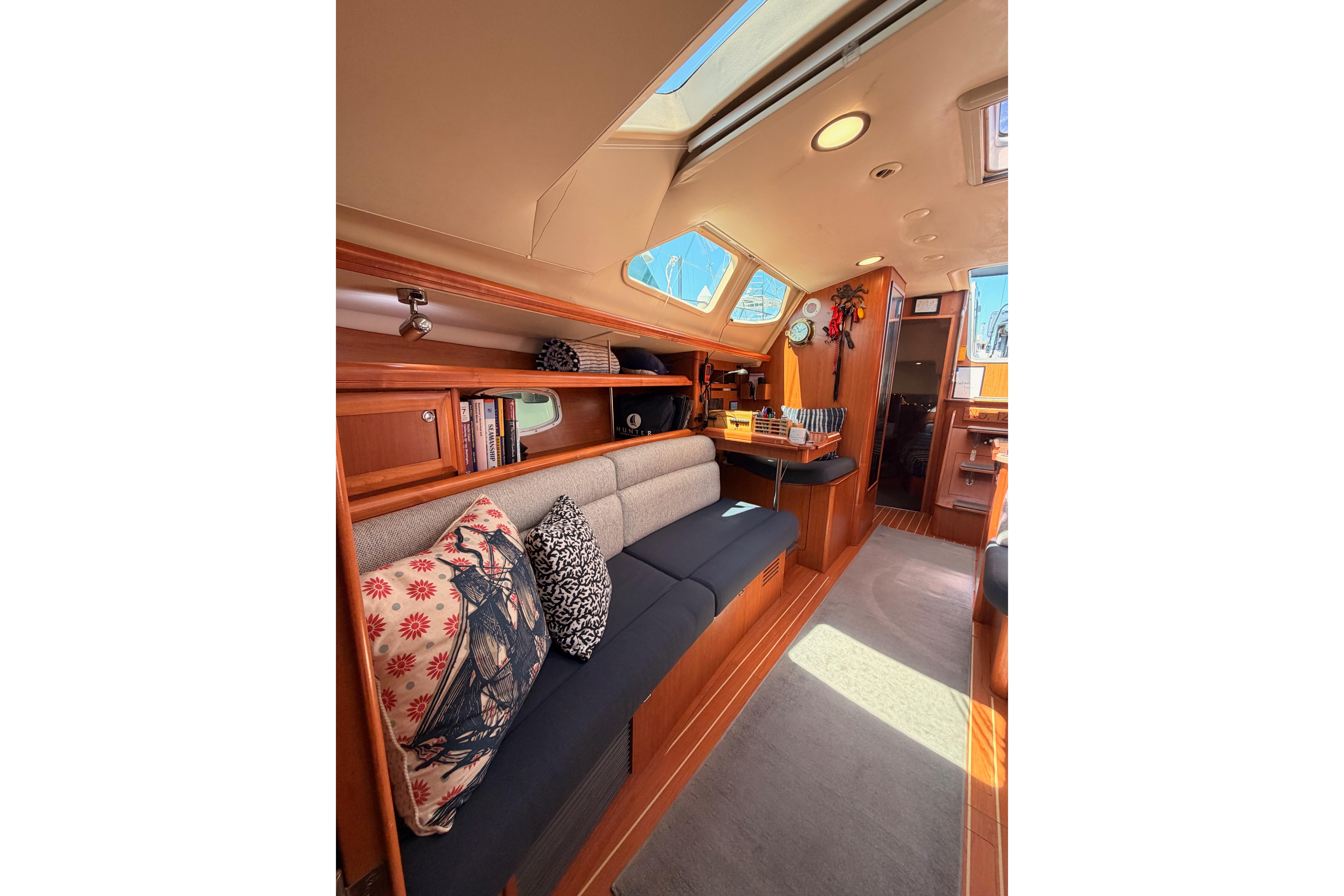 Interior of 2008 Hunter 45 Deck Salon yacht with cozy seating and skylight.