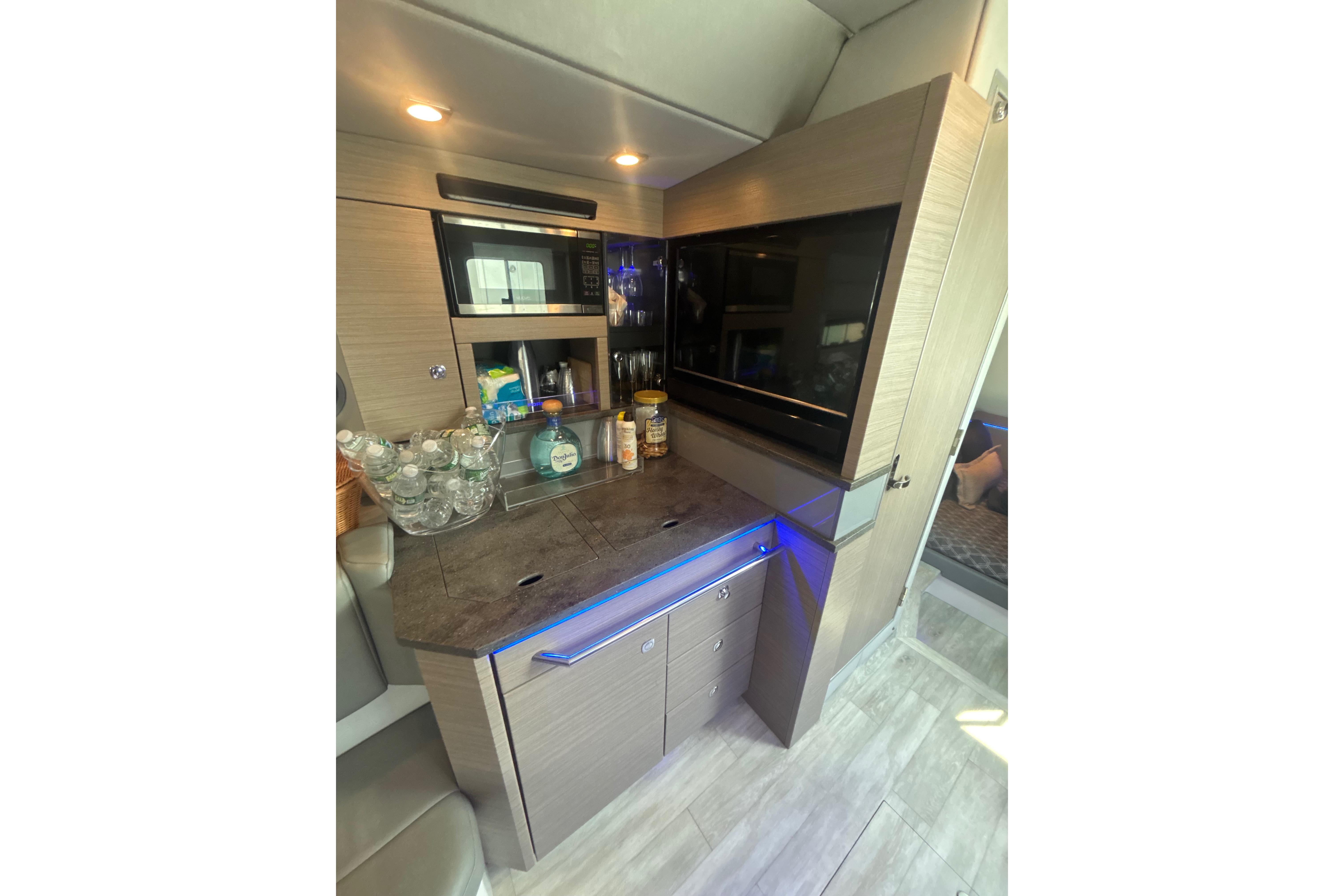 Interior of 2019 Formula 430 Super Sport Crossover with modern kitchenette and sleek cabinetry.