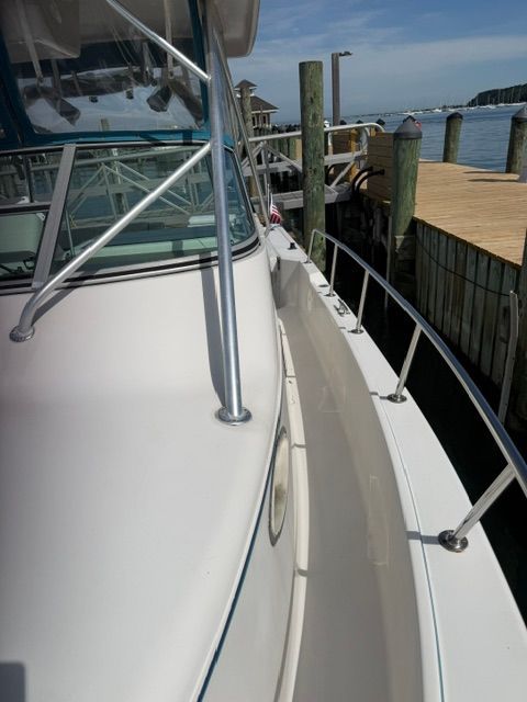 A 1995 Pro-Line 2950 Walkaround docked. Visible are the railing and deck.