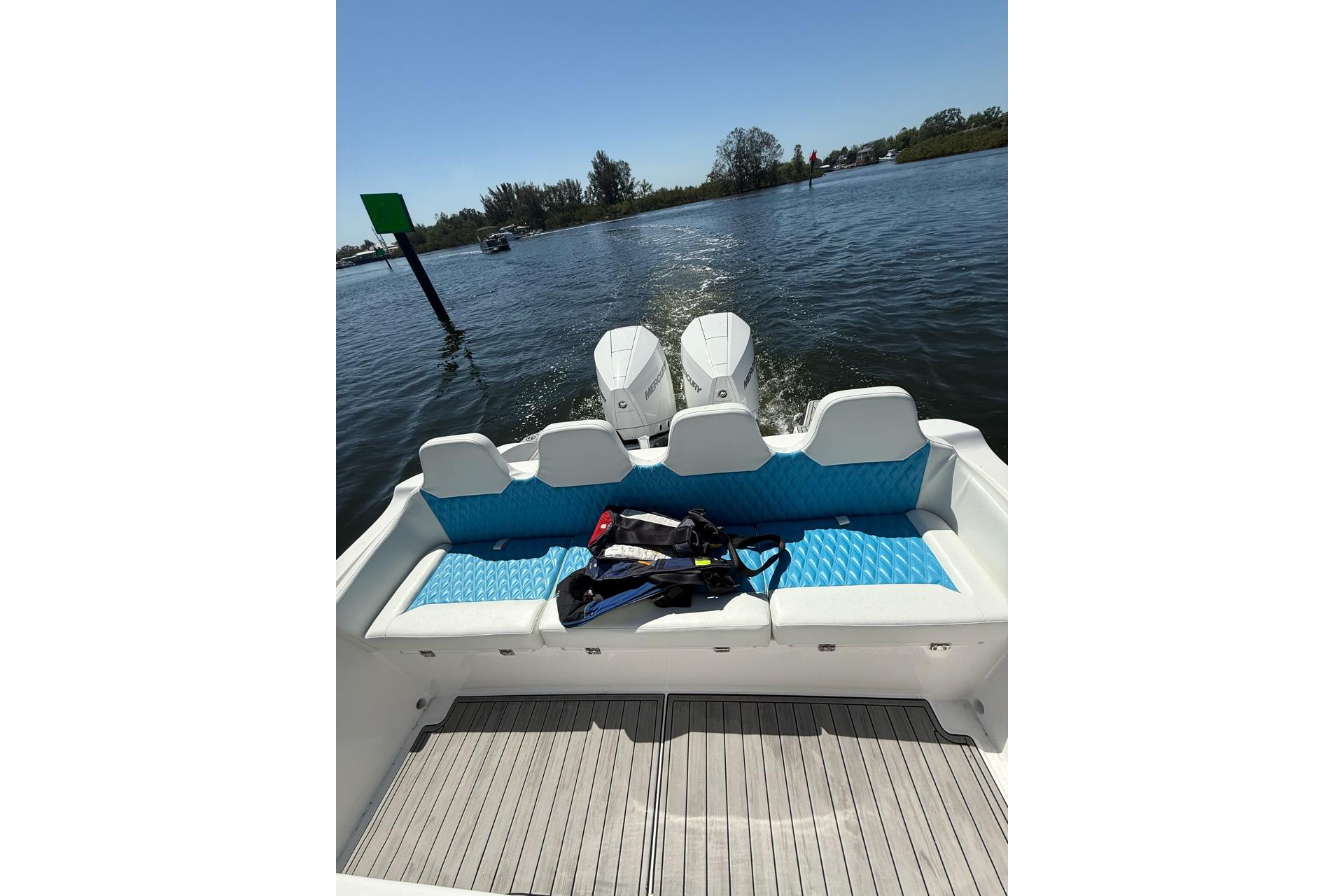 2021 Custom Infusion 34 CC boat with twin engines on a sunny day.