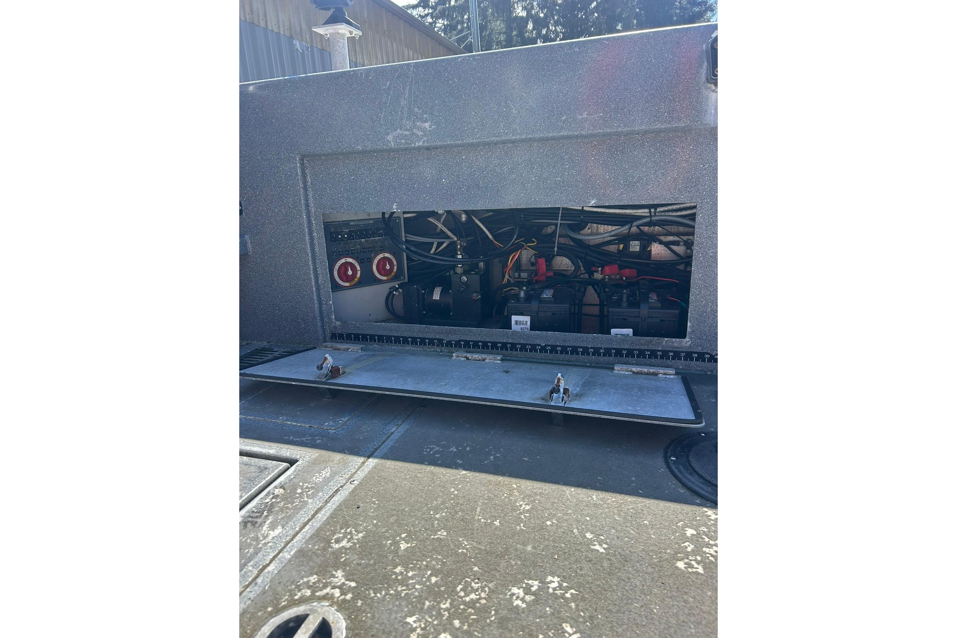 2016 North River 29 Offshore boat compartment with visible wiring and components.