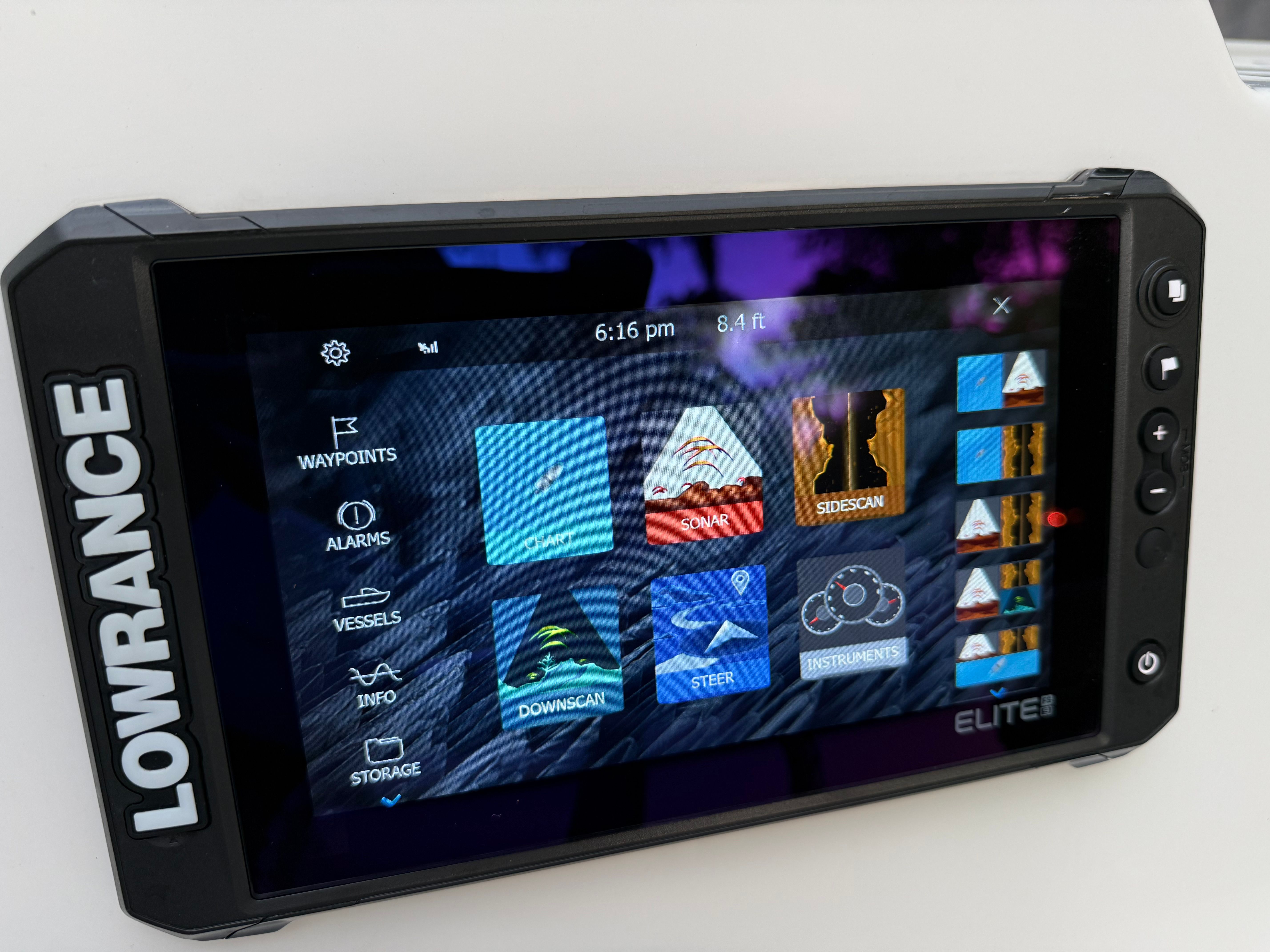 A Lowrance Elite screen displays navigation and sonar features.