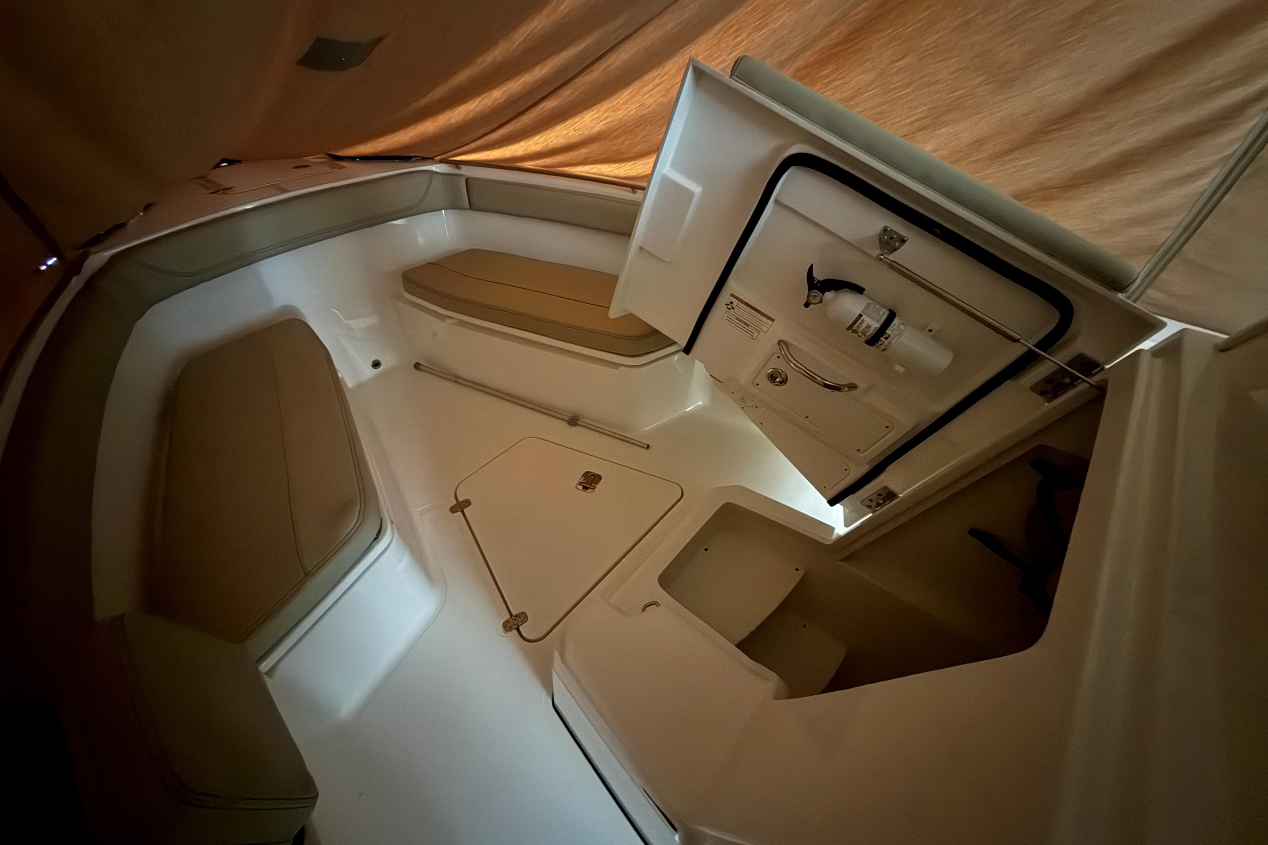 2021 Pursuit S 268 Sport boat interior with seating and storage compartments.