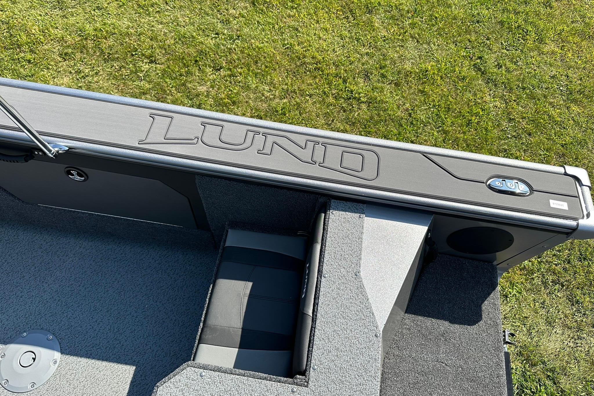 2026 Lund 1875 Fisherman boat interior with logo, gray seating, and carpeted flooring.