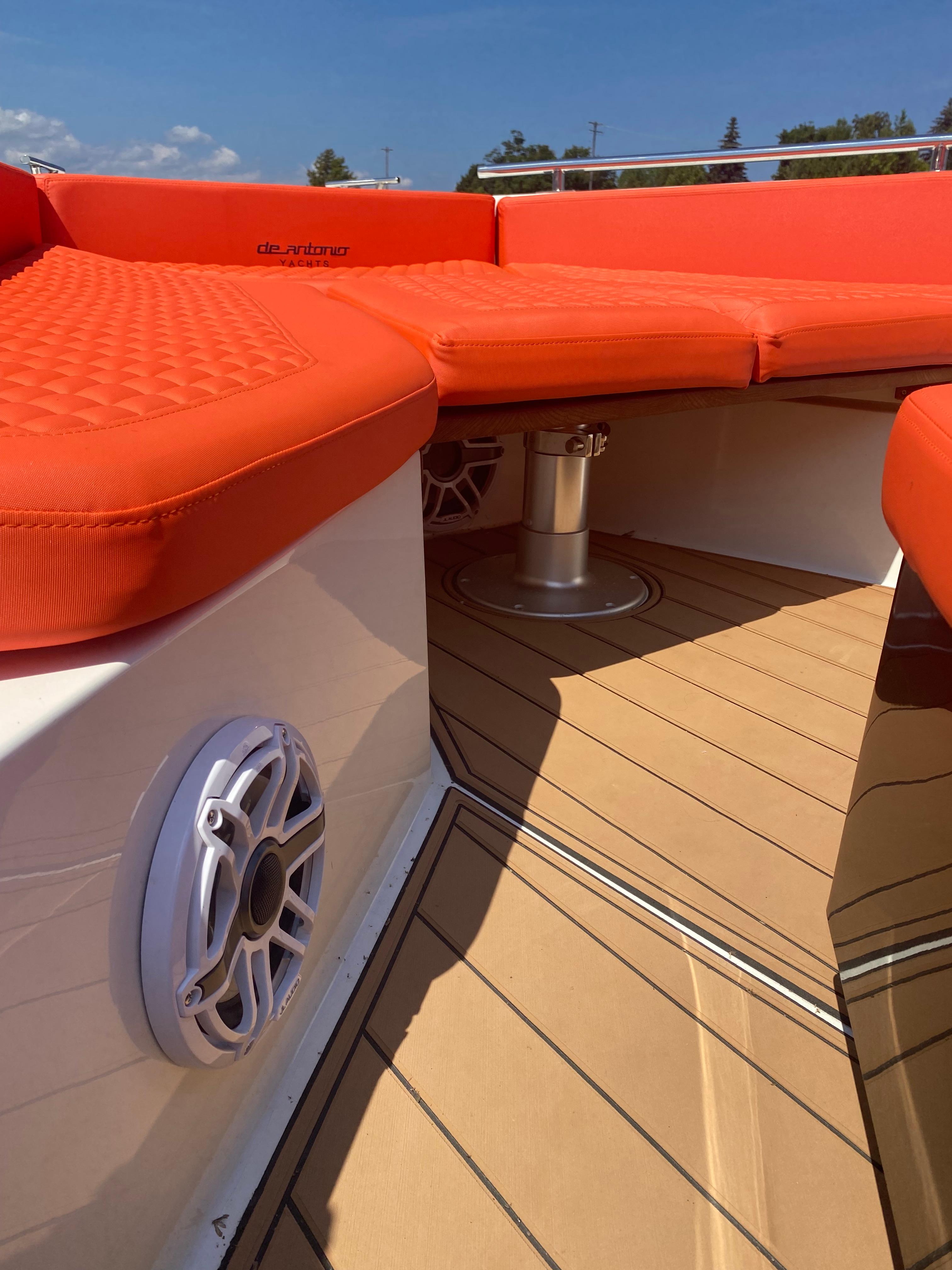 De Antonio Yachts D 28 2020 model with orange seating and teak deck.