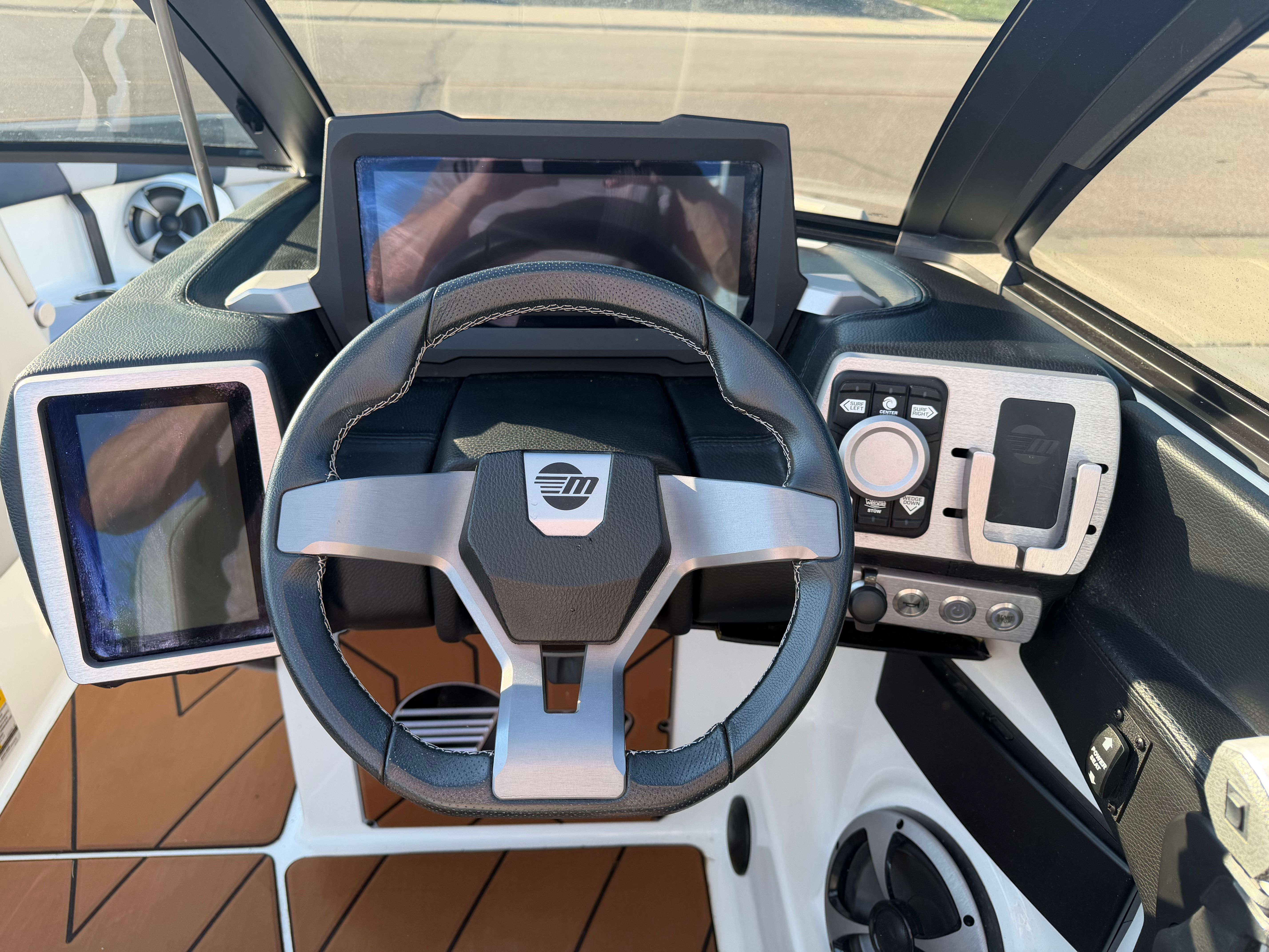 The image shows the cockpit of a 2021 Malibu Wakesetter 23 LSV with modern controls.