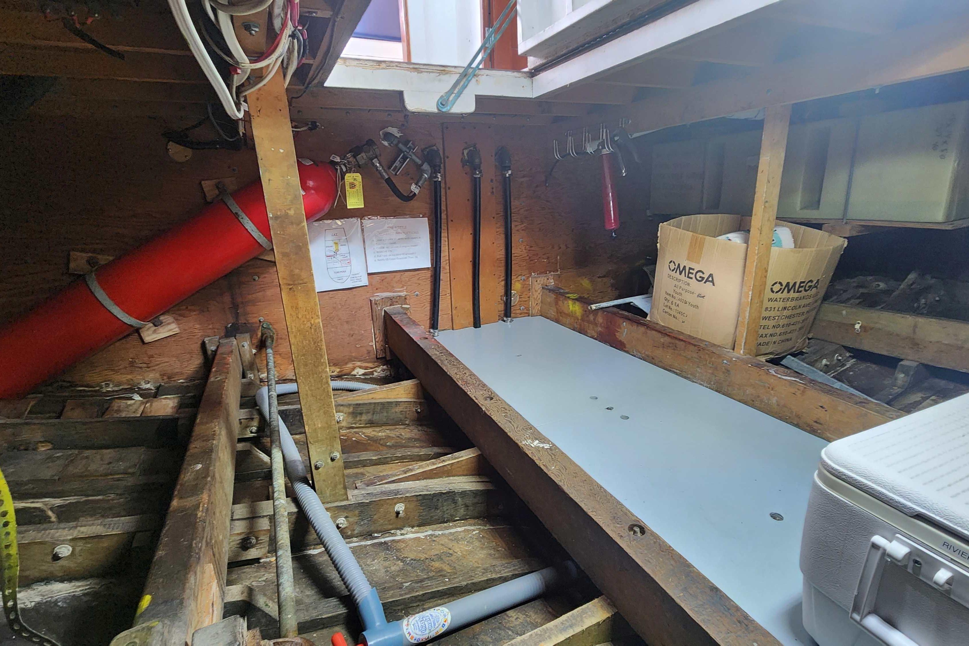 Interior of a 1964 Grandy Tour Boat showing storage and equipment setup.