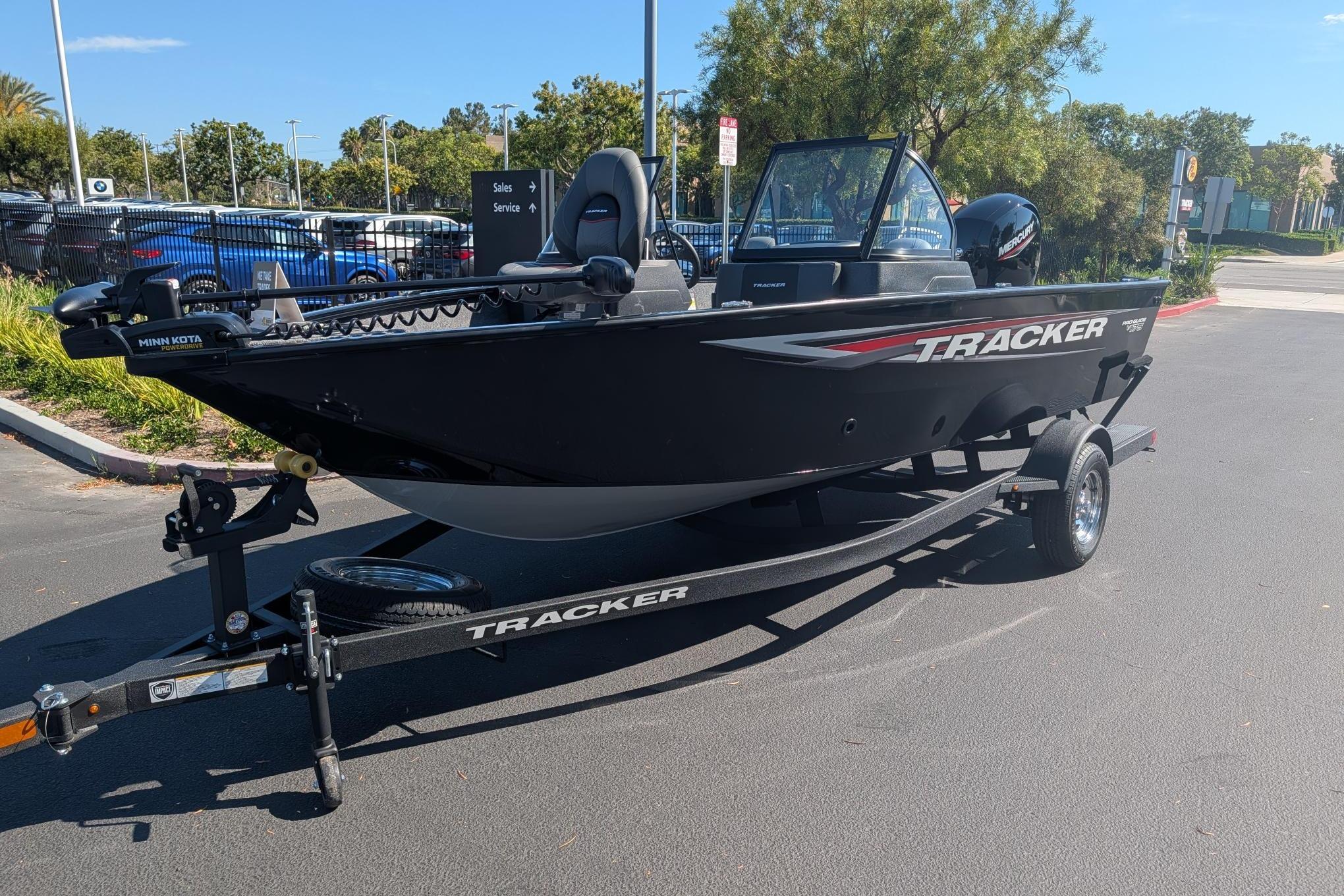 2026 Tracker Pro Guide V-175 Combo boat on trailer in parking lot.