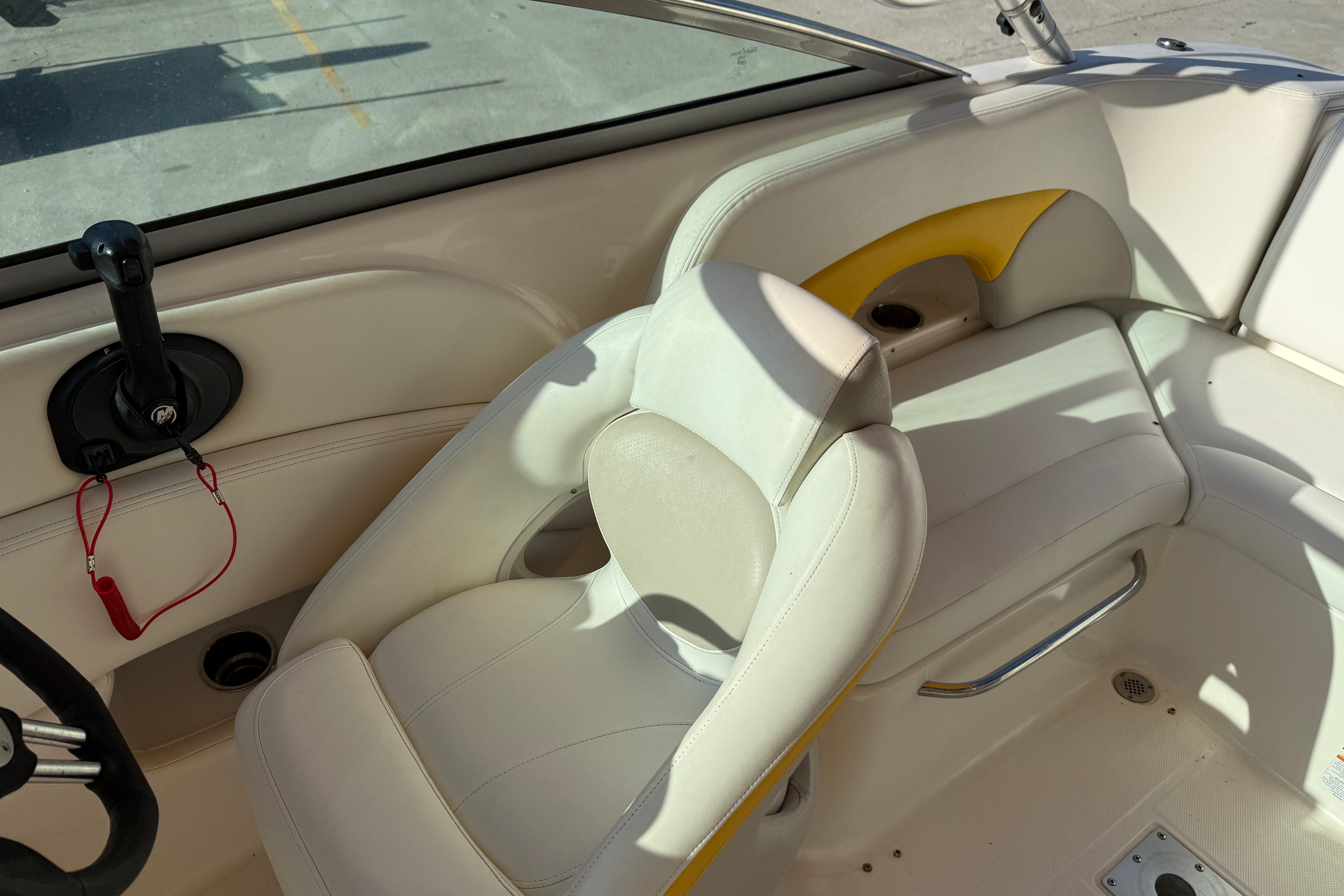 2008 Chaparral 236 SSX boat interior with white seating and steering wheel.