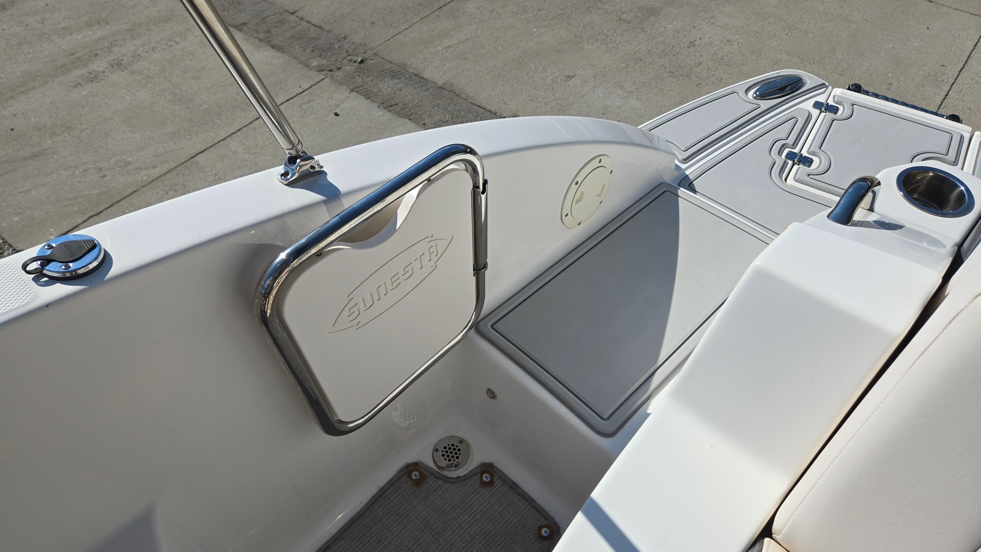 2018 Chaparral 224 Sunesta boat interior with Sunesta-branded door and cup holders.