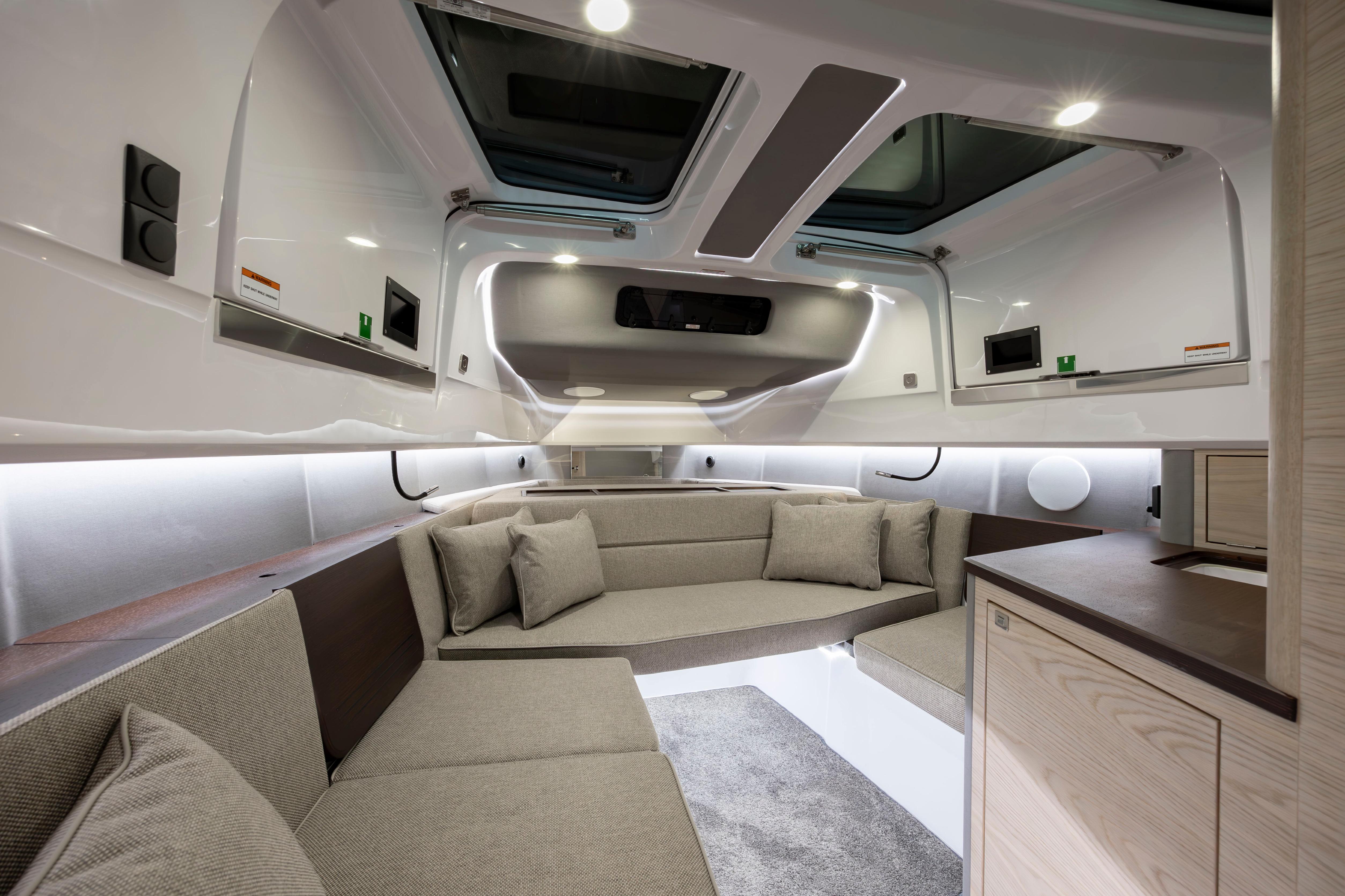 Luxurious interior of 2027 Axopar 45 XC Cross Cabin with modern seating and skylights.