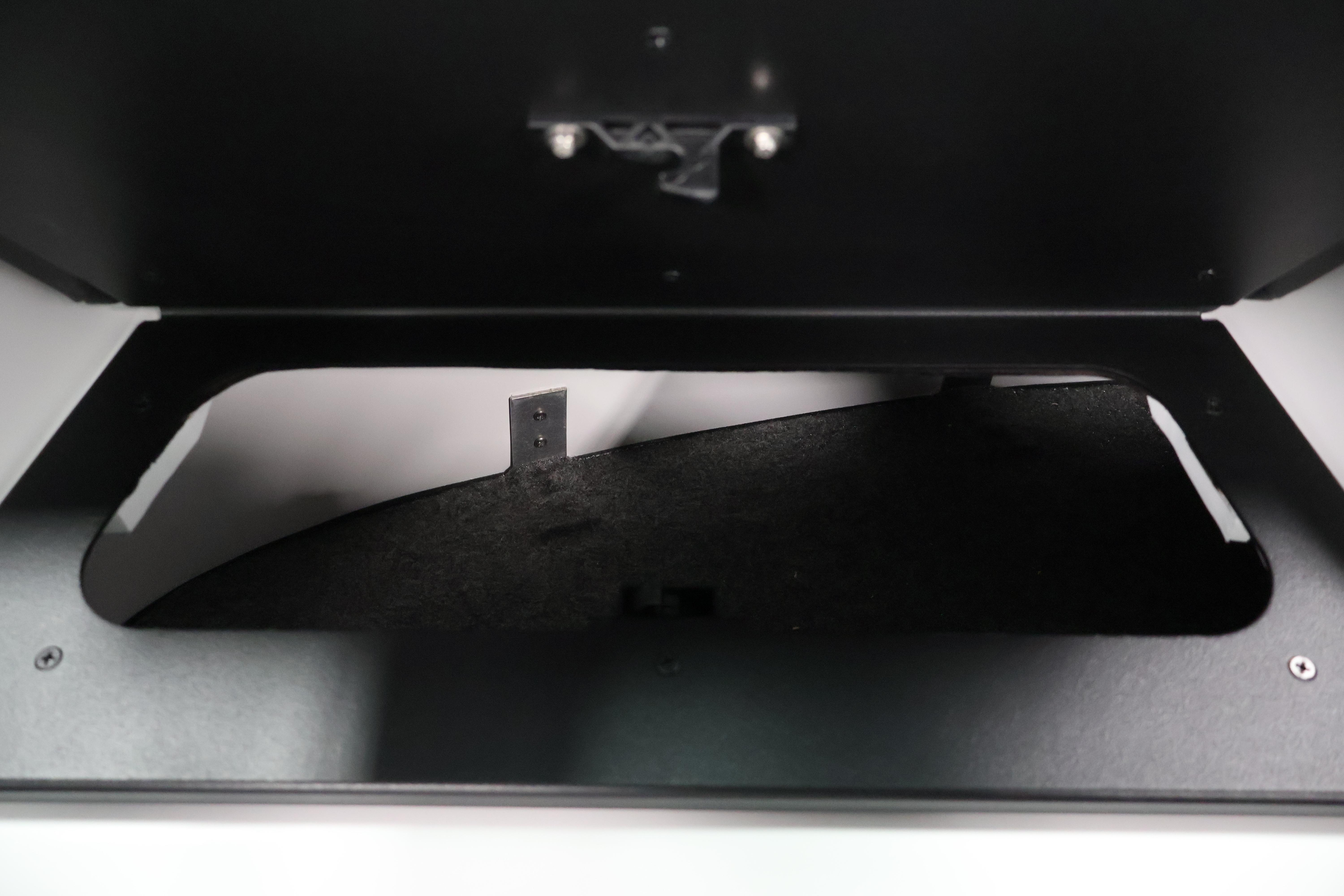 Storage compartment of 2026 Four Winns H4 Freedom boat, featuring a sleek black interior.