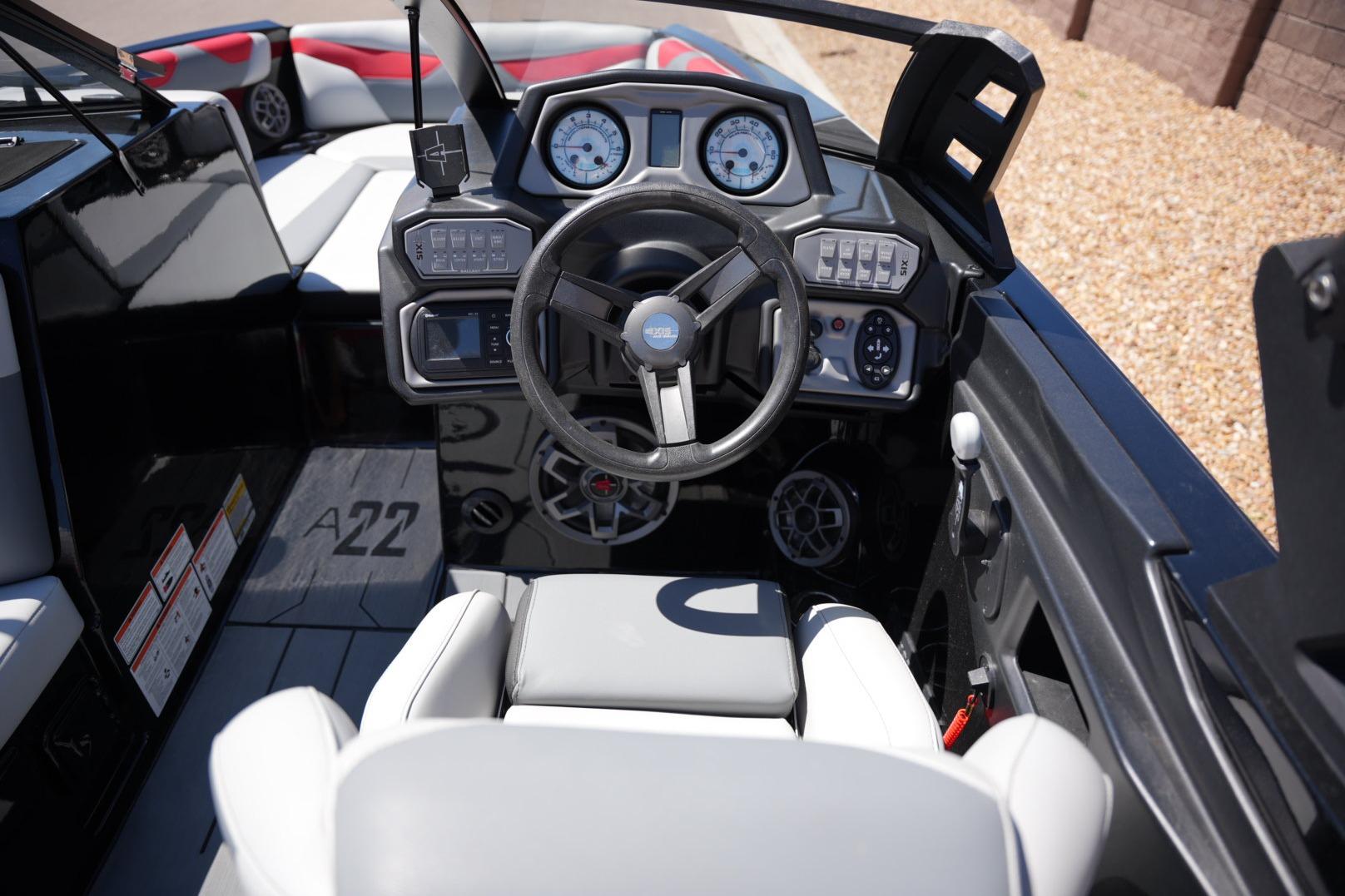 2019 Axis A22 boat cockpit with steering wheel and dashboard controls.