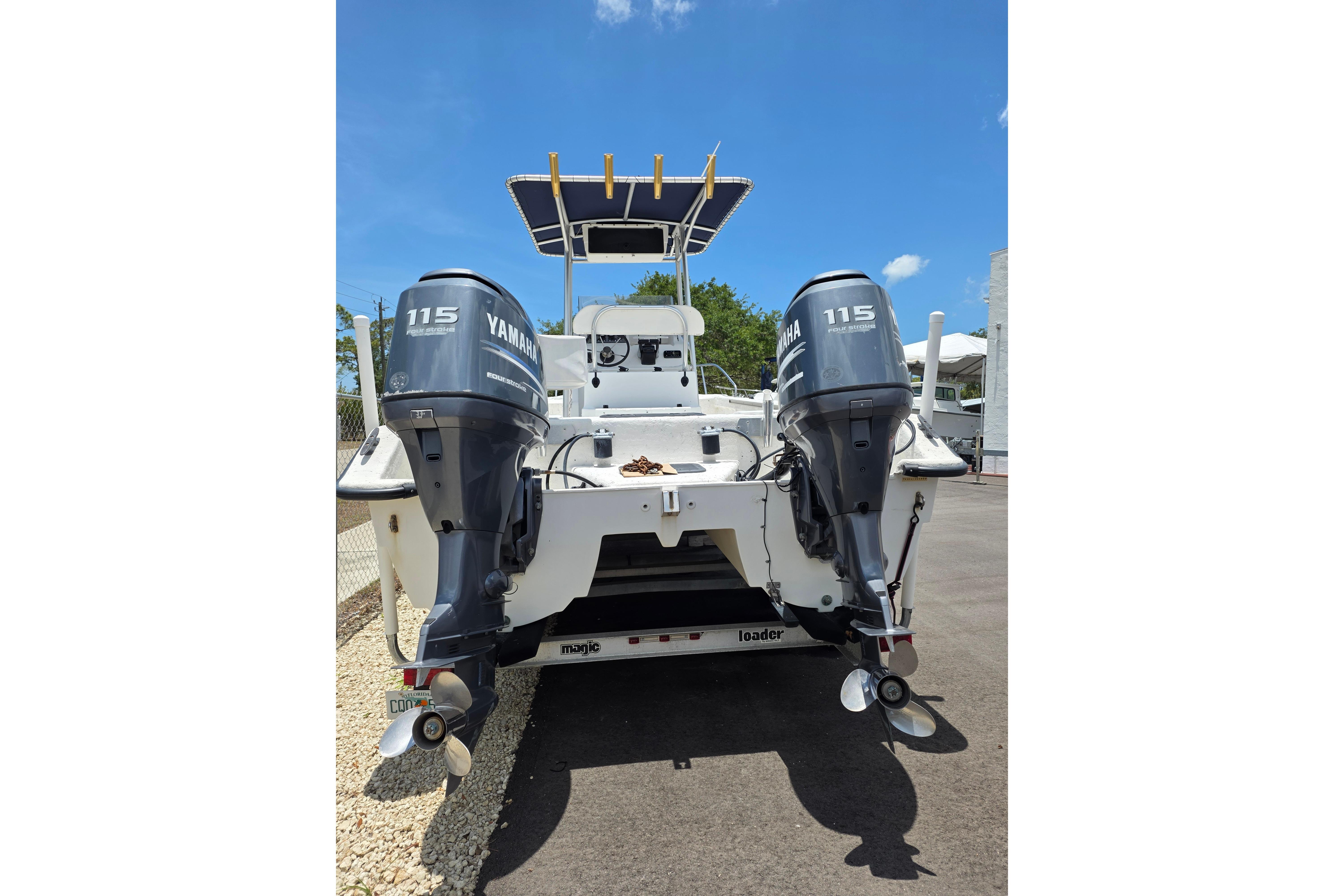 Twin Vee Awesome 22 boat, 1999 model, with dual Yamaha 115 engines, parked outdoors.