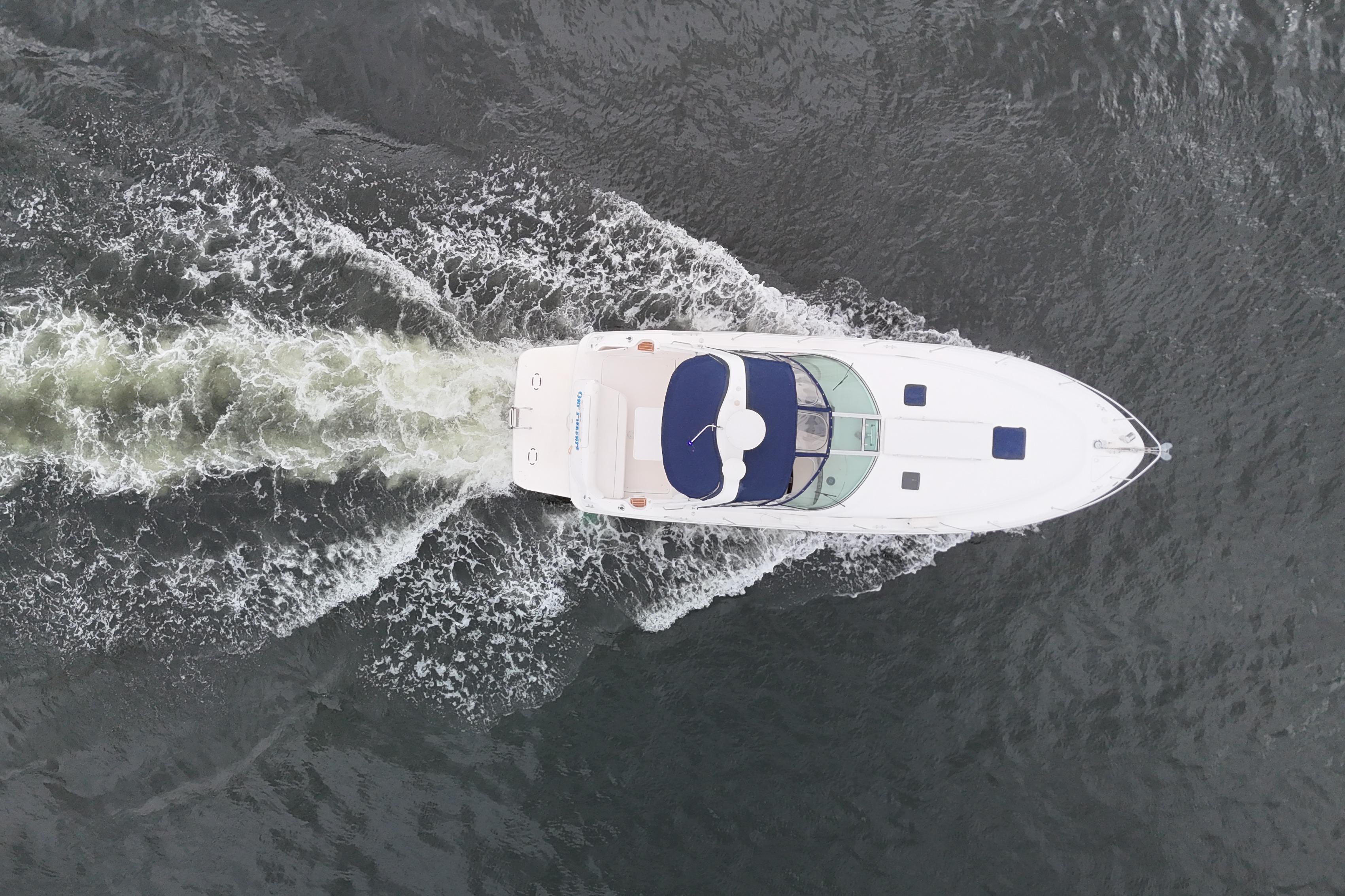 Overhead view of a 1999 Sea Ray 340 boat cruising on water.