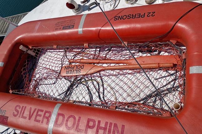 Life raft labeled "Silver Dolphin" on 1980 Thompson trawler, capacity 22 persons.