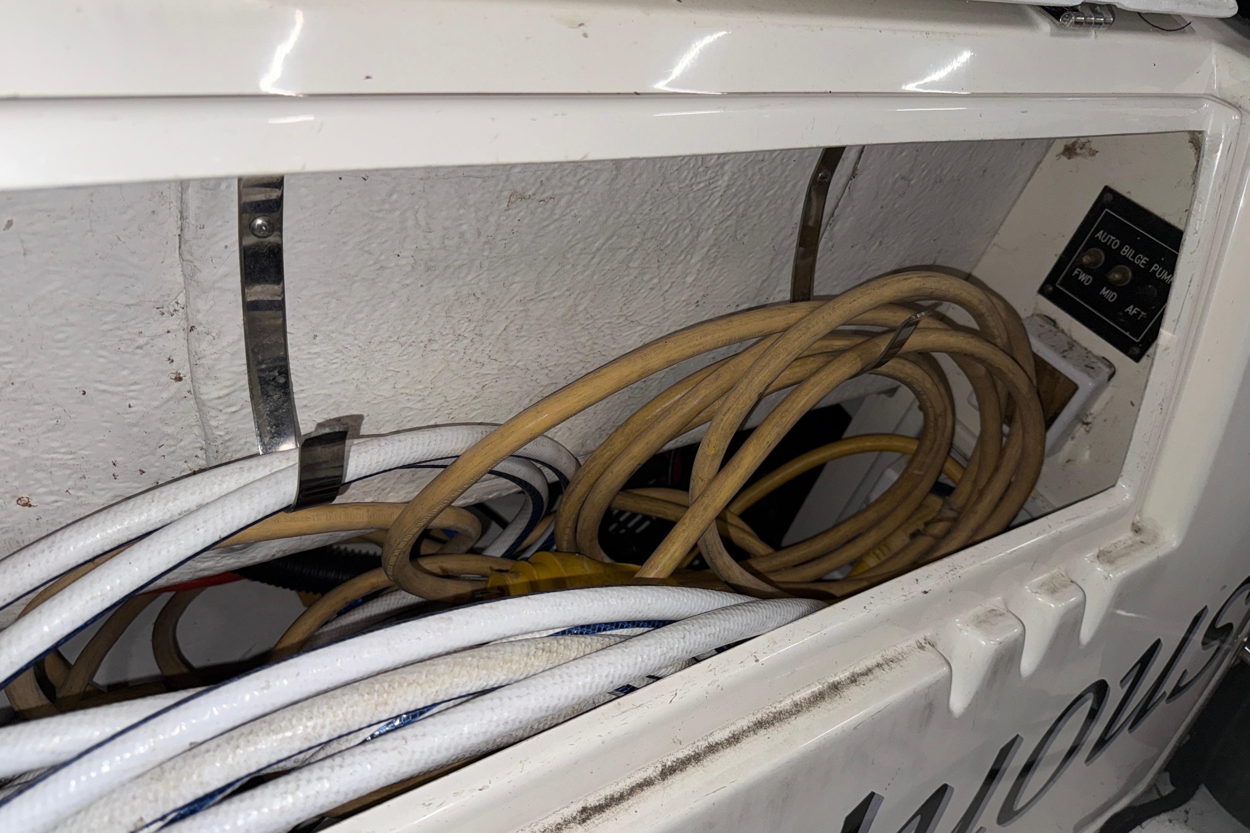 2004 Cruisers Yachts 340 Express wiring compartment with cables and bilge pump controls.