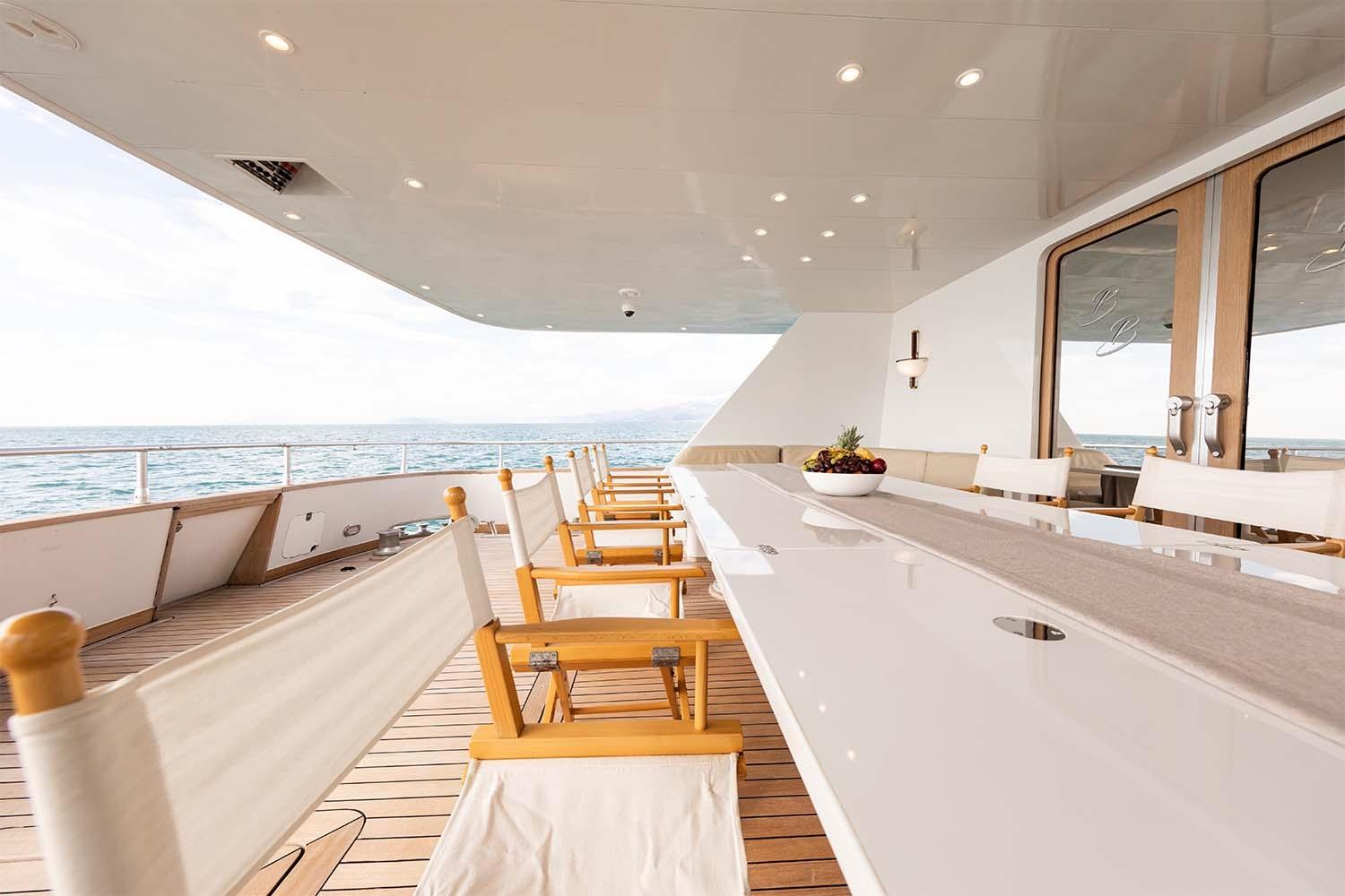 Luxurious deck of 1992 Admiral 28 yacht with elegant dining area and ocean view.