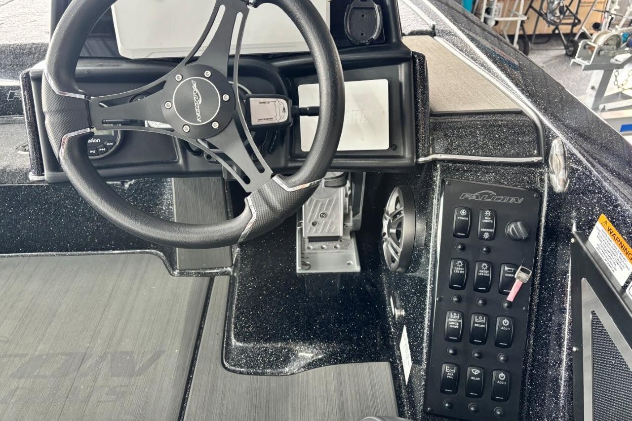 Steering console of 2025 Falcon Boats 21 Predator with control panel and switches.
