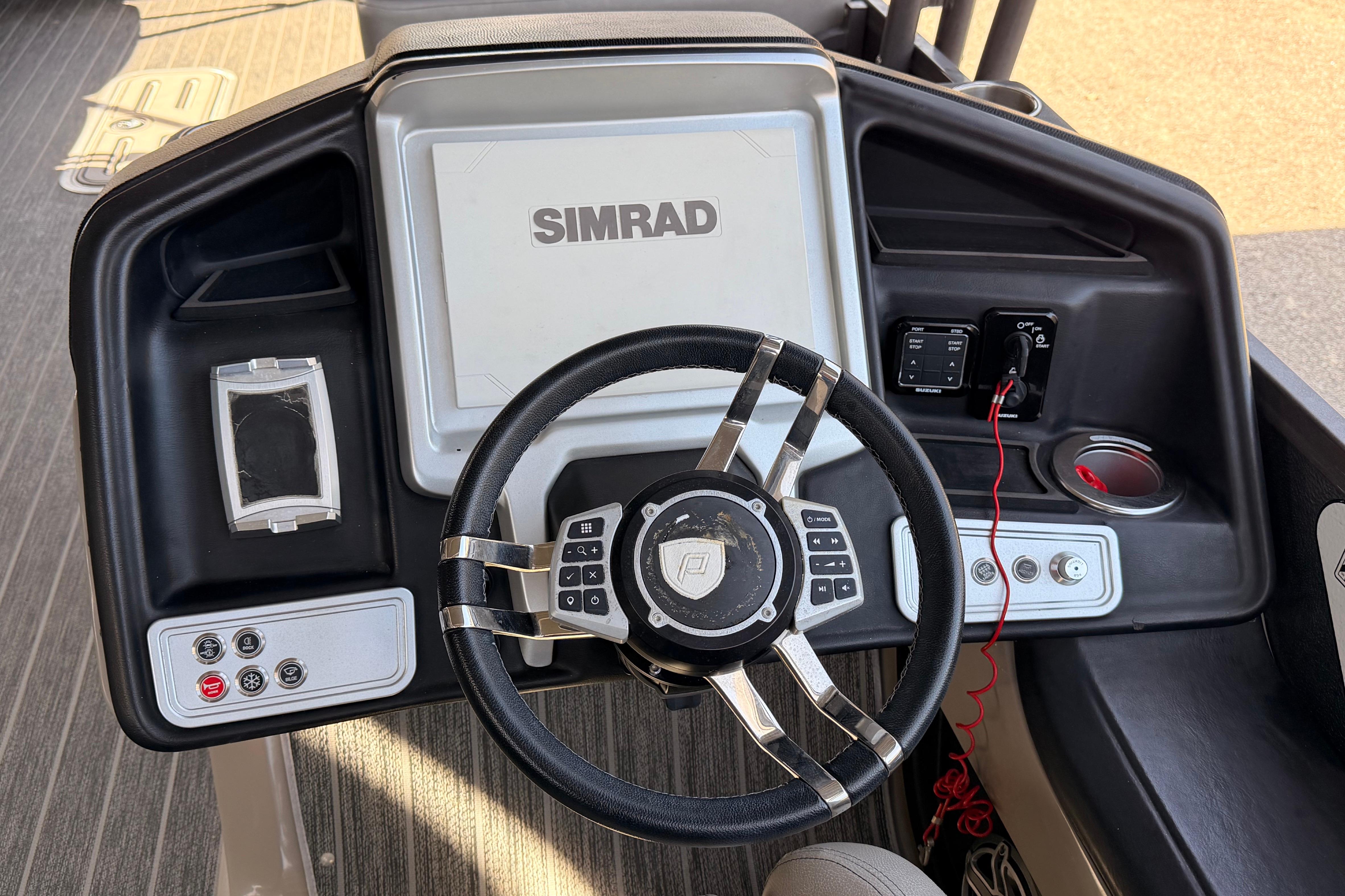 Steering console of 2022 Premier 350 Escalante with Simrad display and controls.