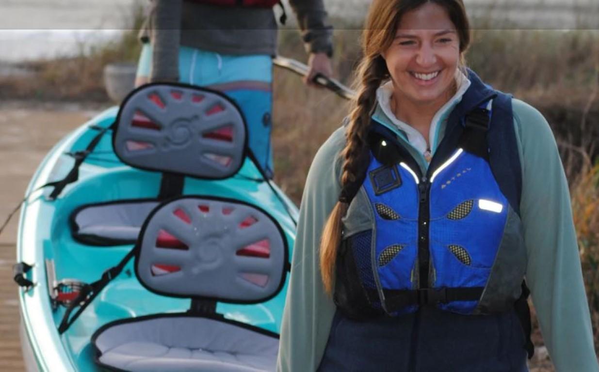 Woman with life jacket near Hurricane Kayaks Skimmer 140 Tandem, 2023 model.