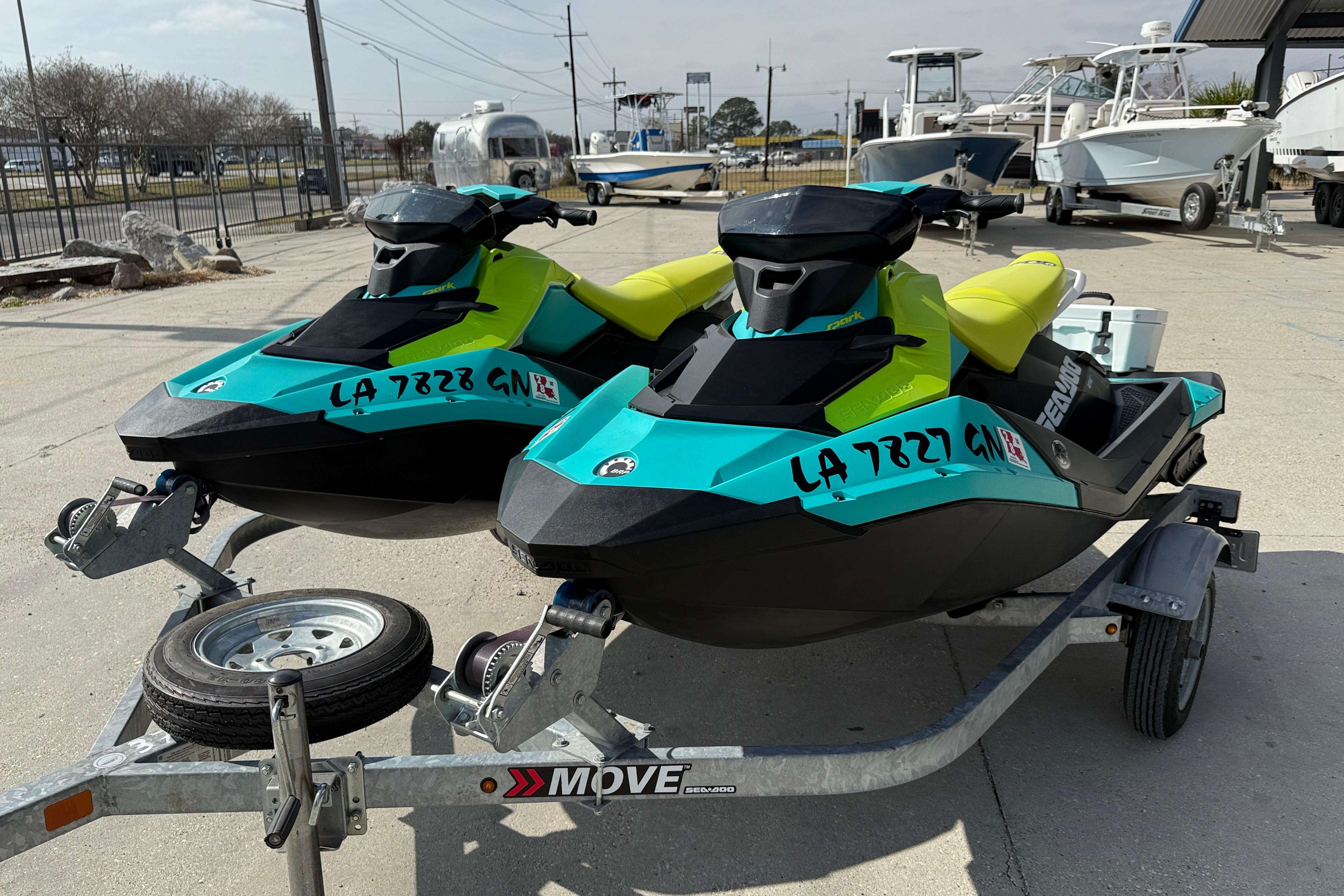 2022 Sea-Doo Spark 3up jet skis on trailer, vibrant colors, parked outdoors.