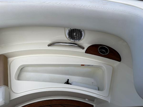 2014 Chris-Craft 28 LAUNCH boat interior detail with speaker and storage compartment.