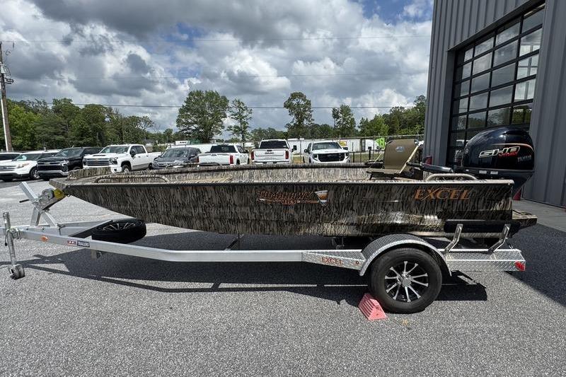 2026 Excel 183 Tomahawk boat on trailer, parked outdoors under cloudy sky.