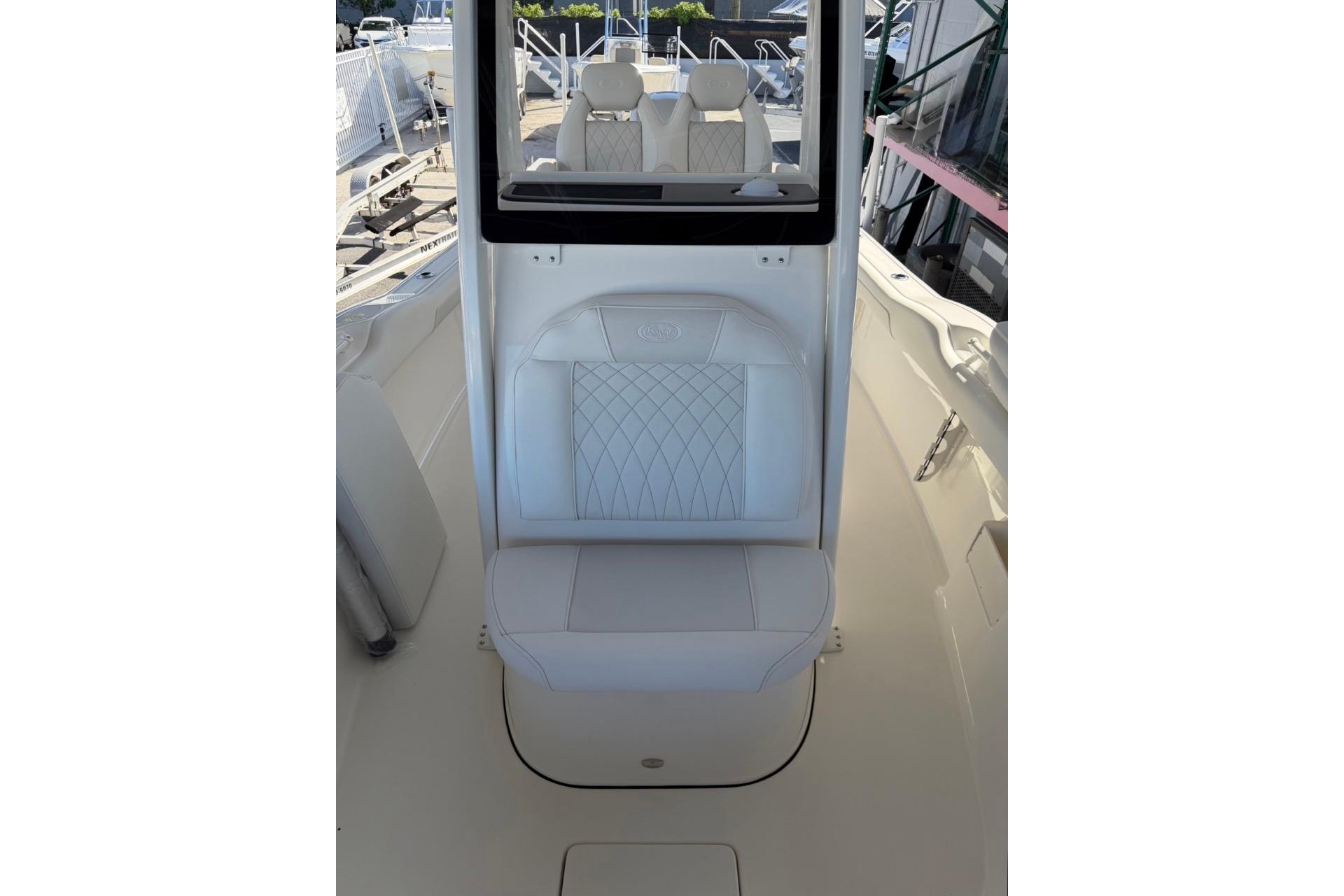2026 Key West 239 FSR boat interior with white cushioned seating and sleek design.
