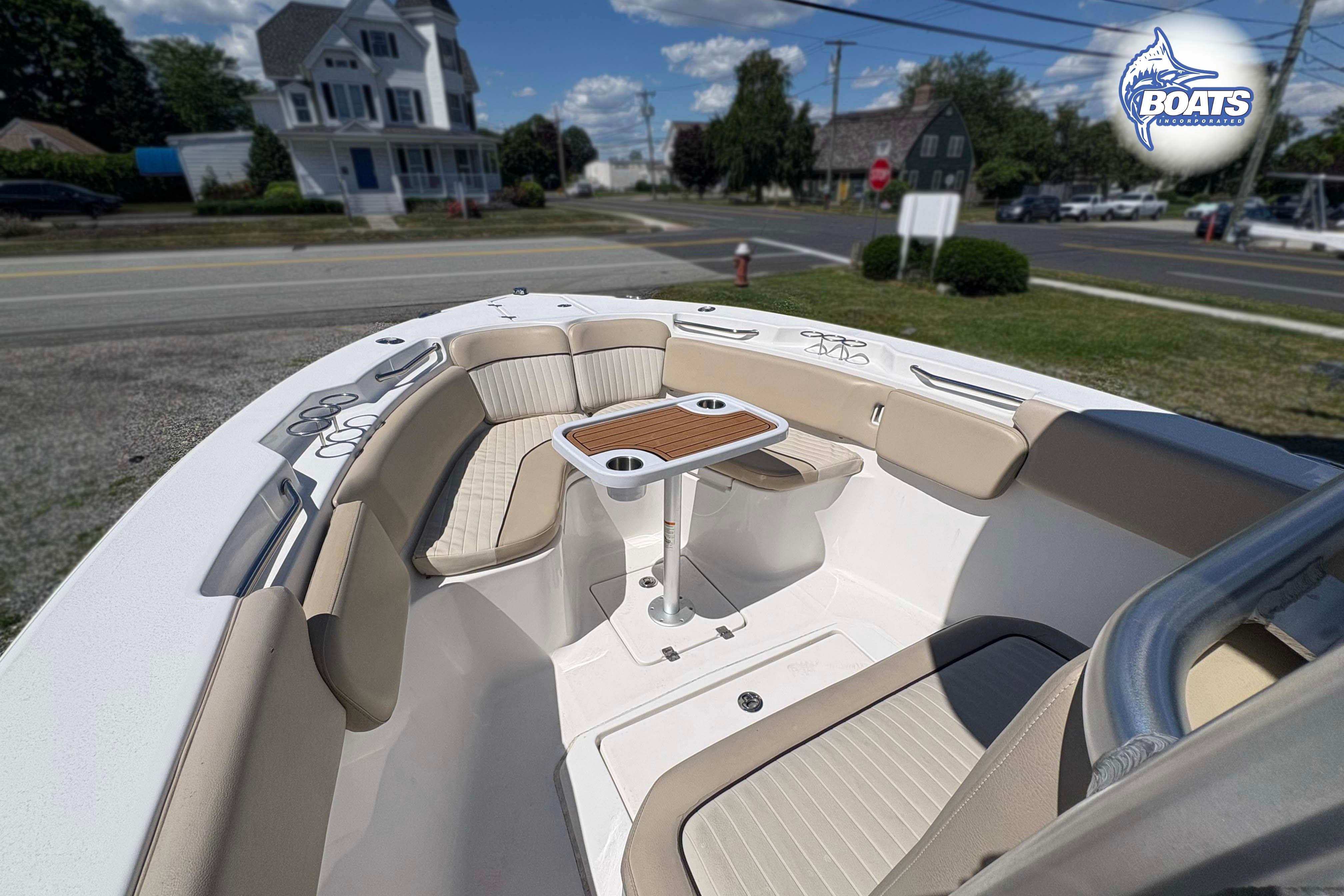 2015 Sea Fox 266 Commander boat interior with seating and table, parked near a road.