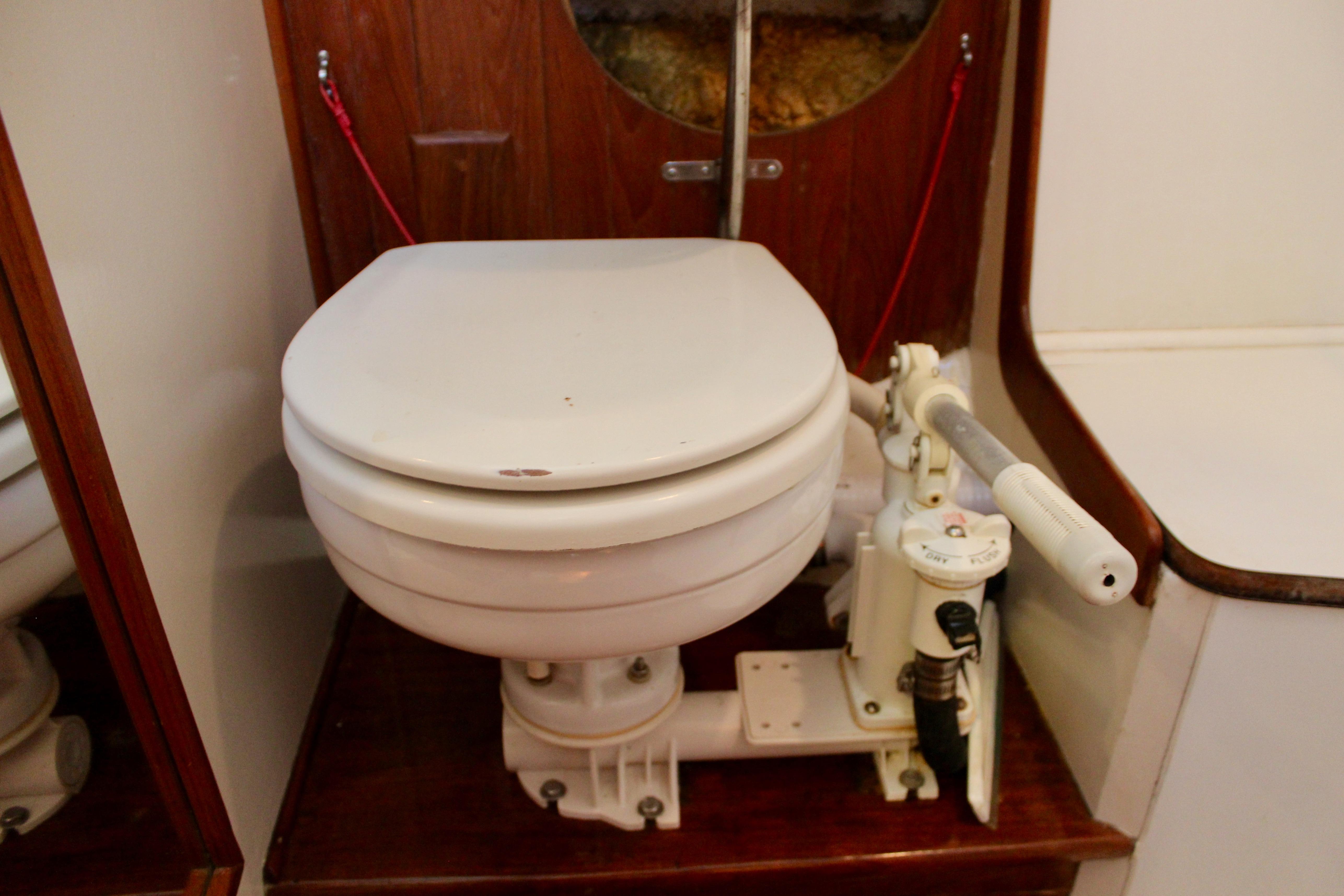 Marine toilet in a 1981 Kelly Peterson 46 sailboat, featuring manual pump system.