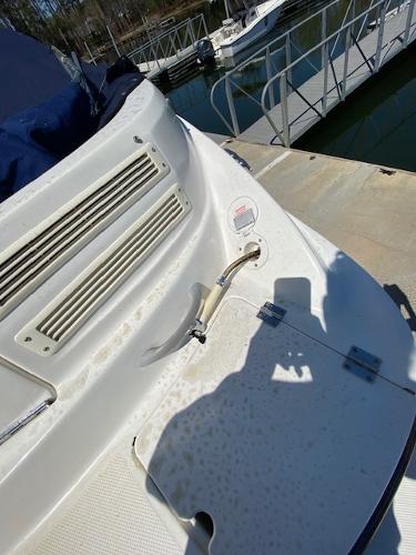 2005 Bayliner 249 SD boat docked, showing deck details and marina background.