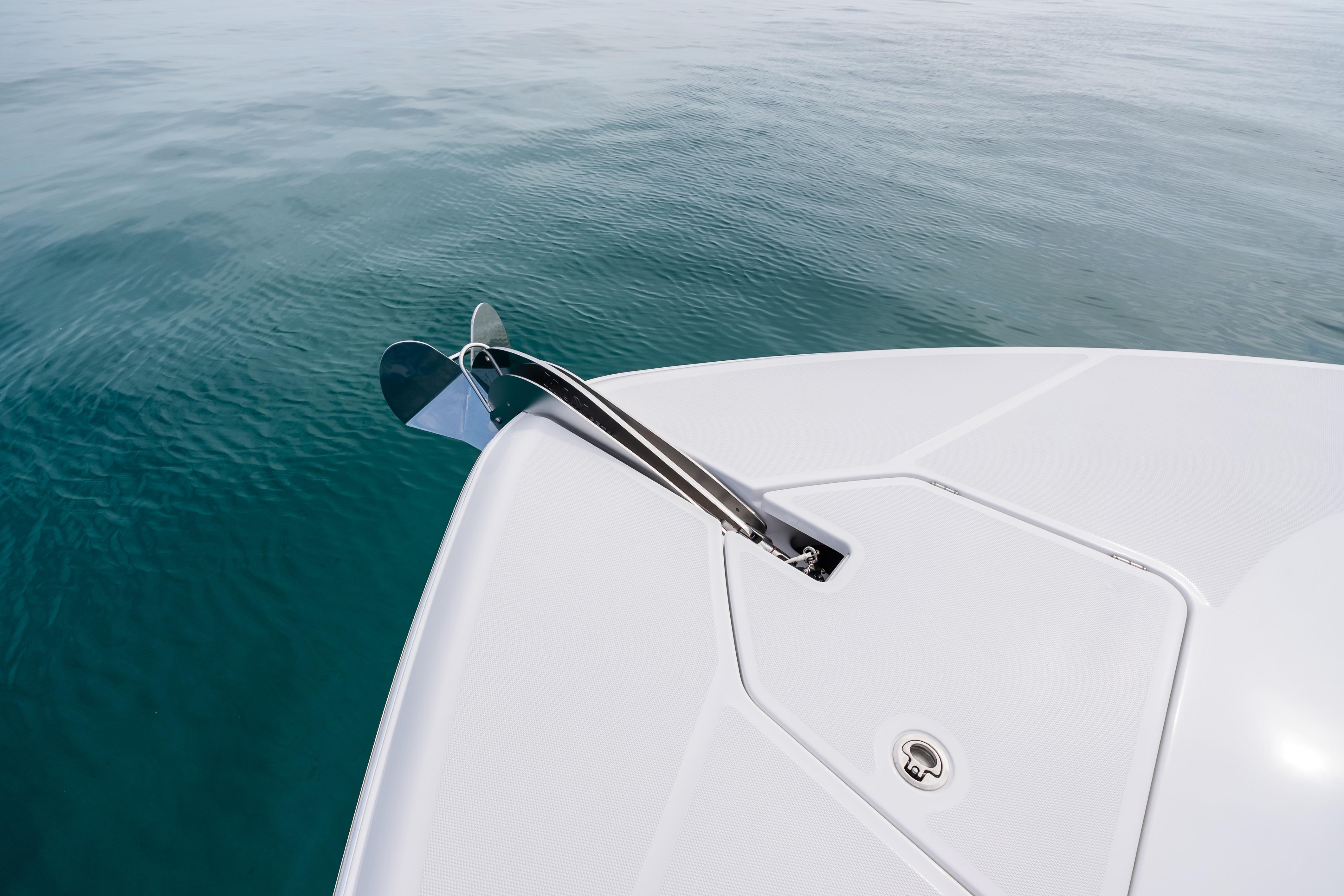 Bow of 2025 HCB 56 Suenos GIX yacht with anchor over clear water.