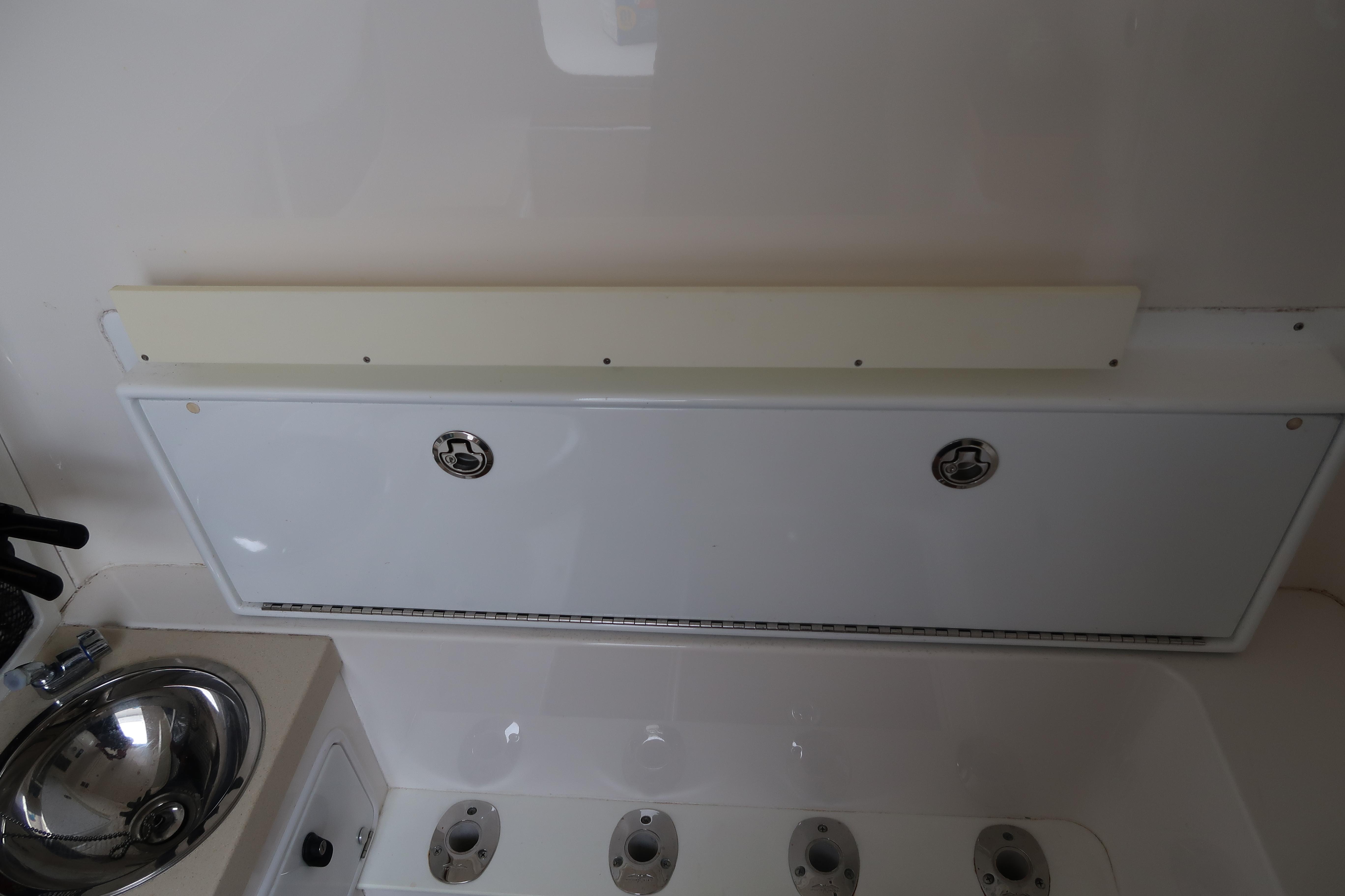 2016 Invincible 42 Open Fisherman boat interior with sink and storage compartments.