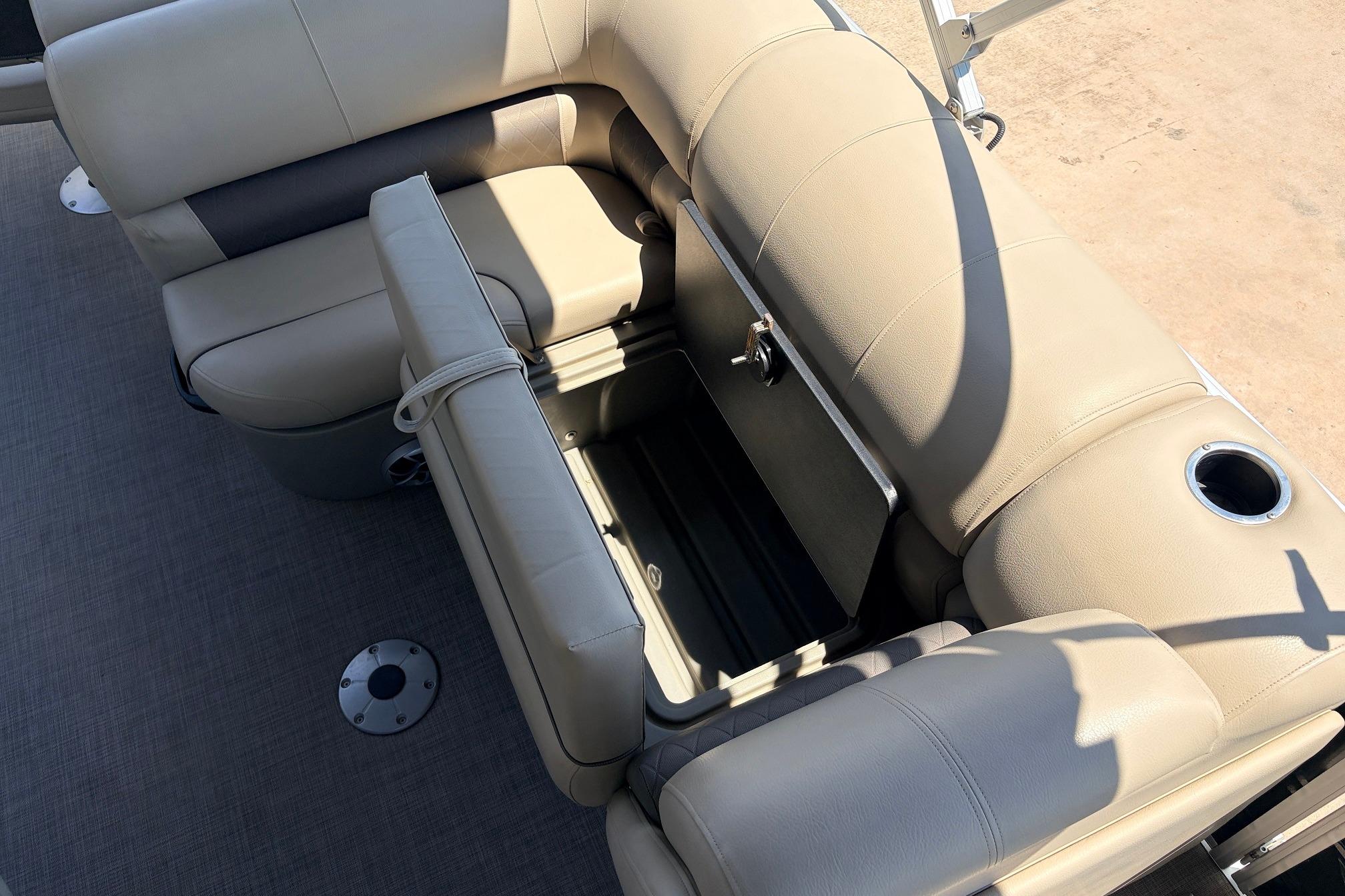2024 Sun Tracker SportFish 22 XP3 boat interior with beige seating and storage compartment.