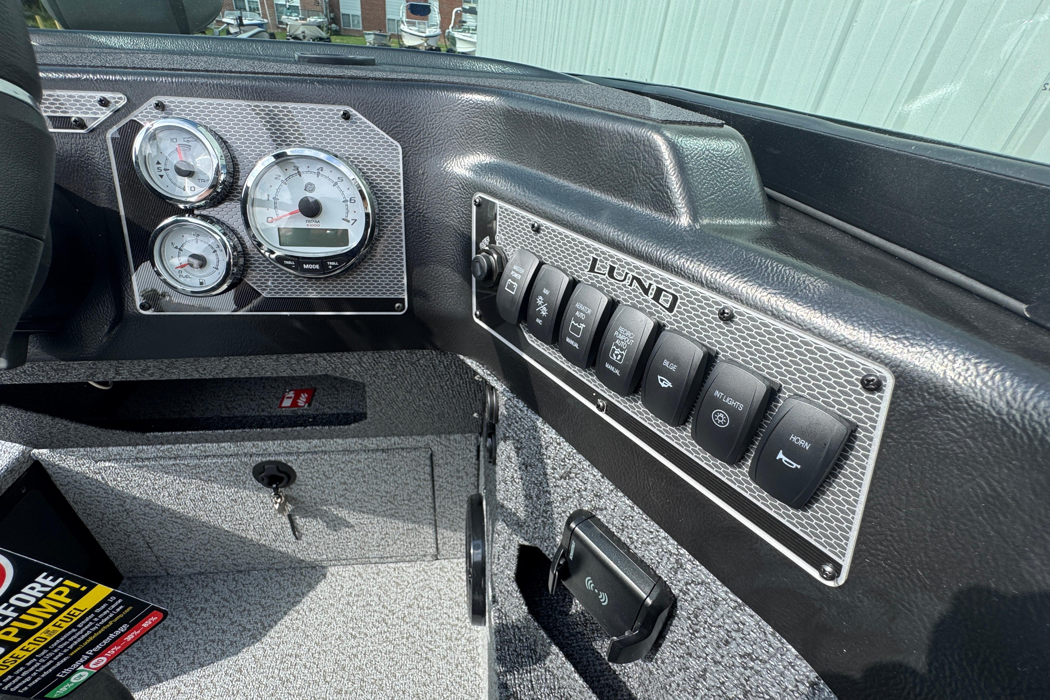 Dashboard of 2026 Lund 2075 Impact XS boat with gauges and control switches.