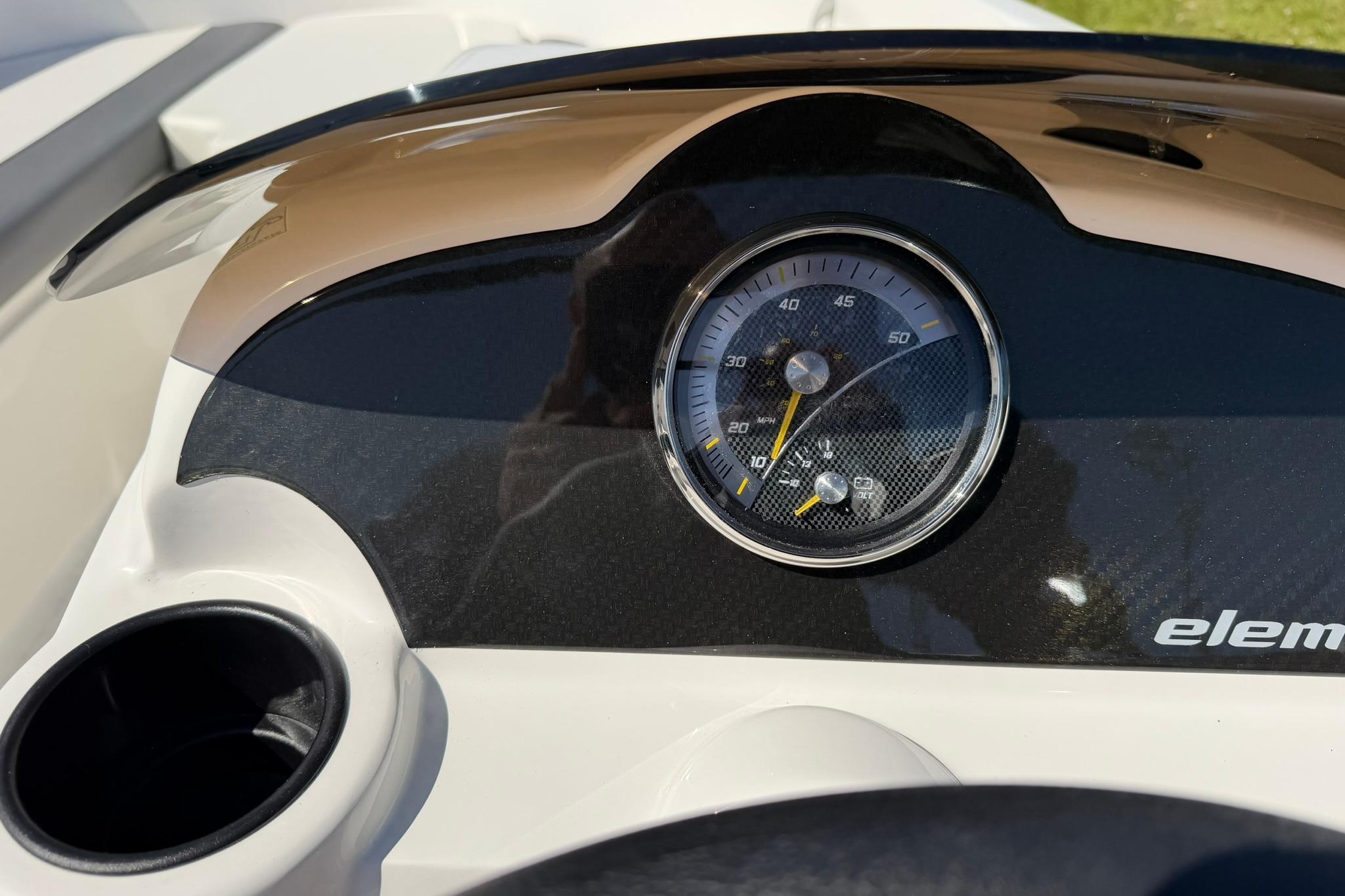 Dashboard of 2026 Bayliner Element E18 boat with speedometer and cup holder.