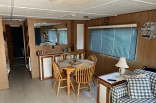 Interior of 1994 PlayCraft 5215 houseboat with dining area and cozy seating.