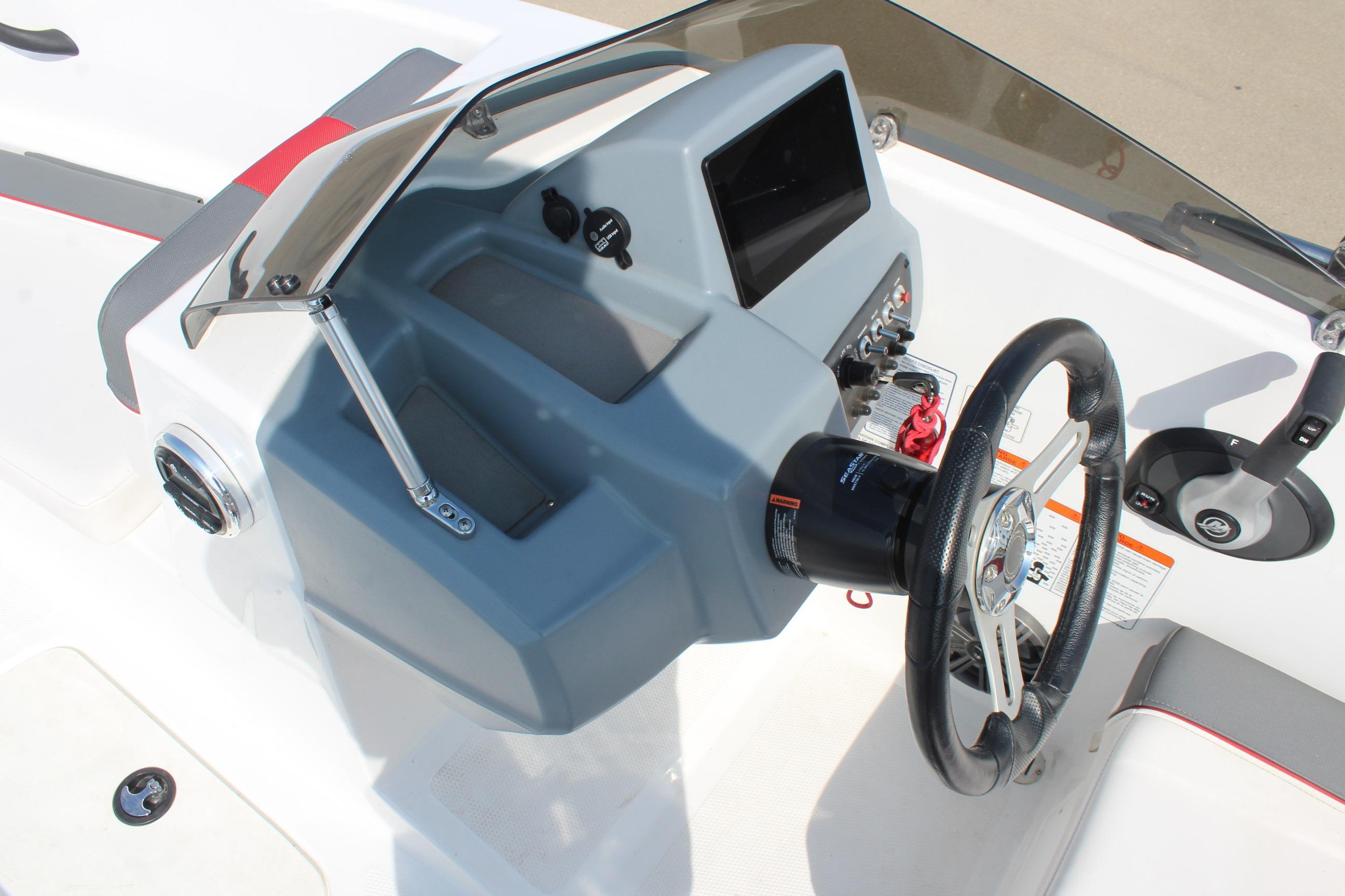 2023 Tahoe T16 boat dashboard with steering wheel and control panel.
