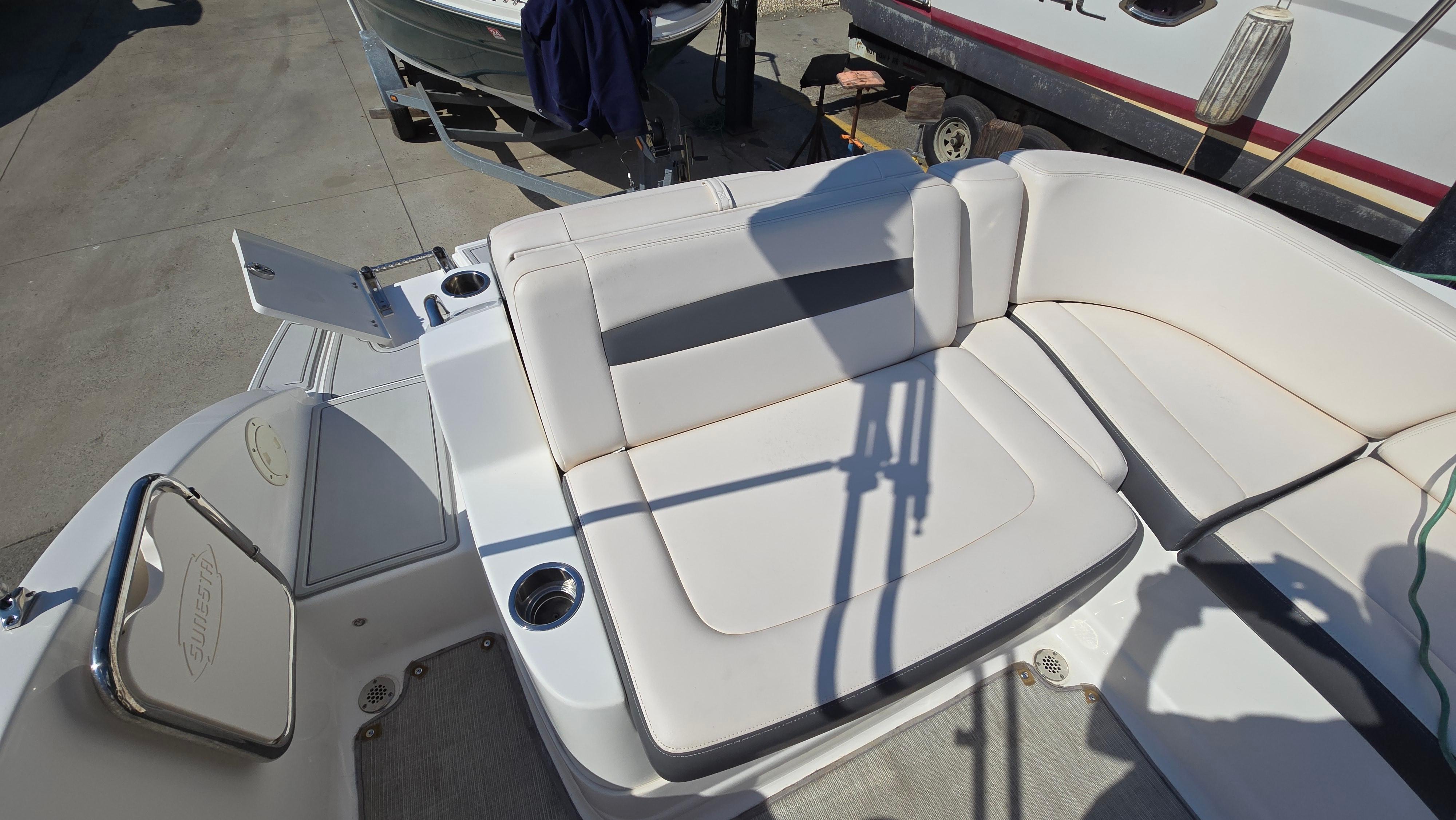 2018 Chaparral 224 Sunesta boat interior with white seating and cup holders.