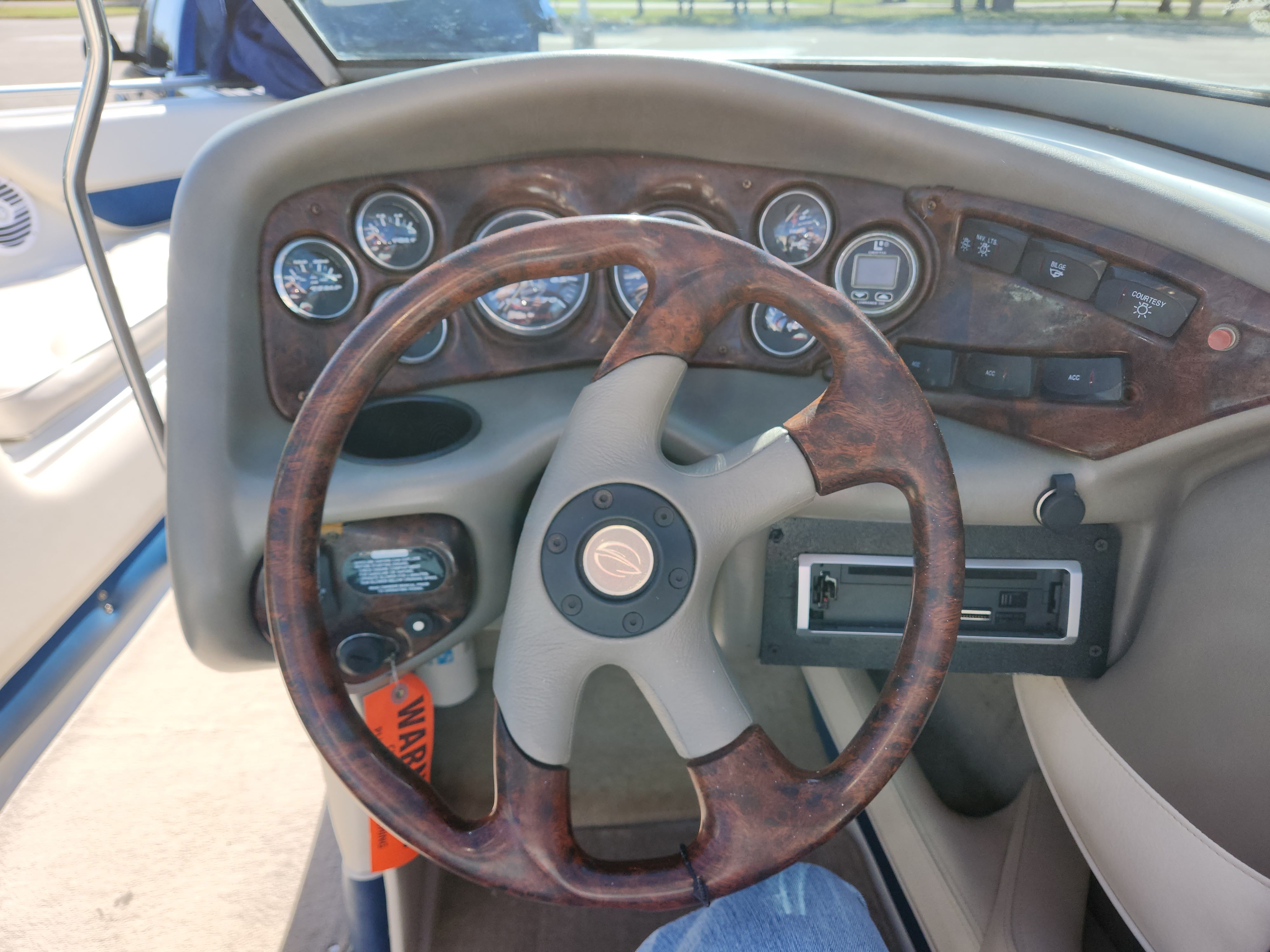 Steering wheel and dashboard of a 2003 Crownline 225 BR boat.