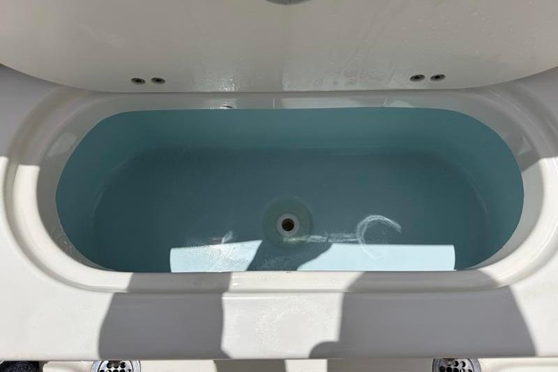 Livewell in 2023 Key West 203 FS boat, filled with water, showcasing interior design.