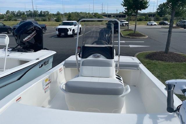 2026 Mako Pro Skiff 13 CC boat in parking lot, featuring center console and outboard motor.