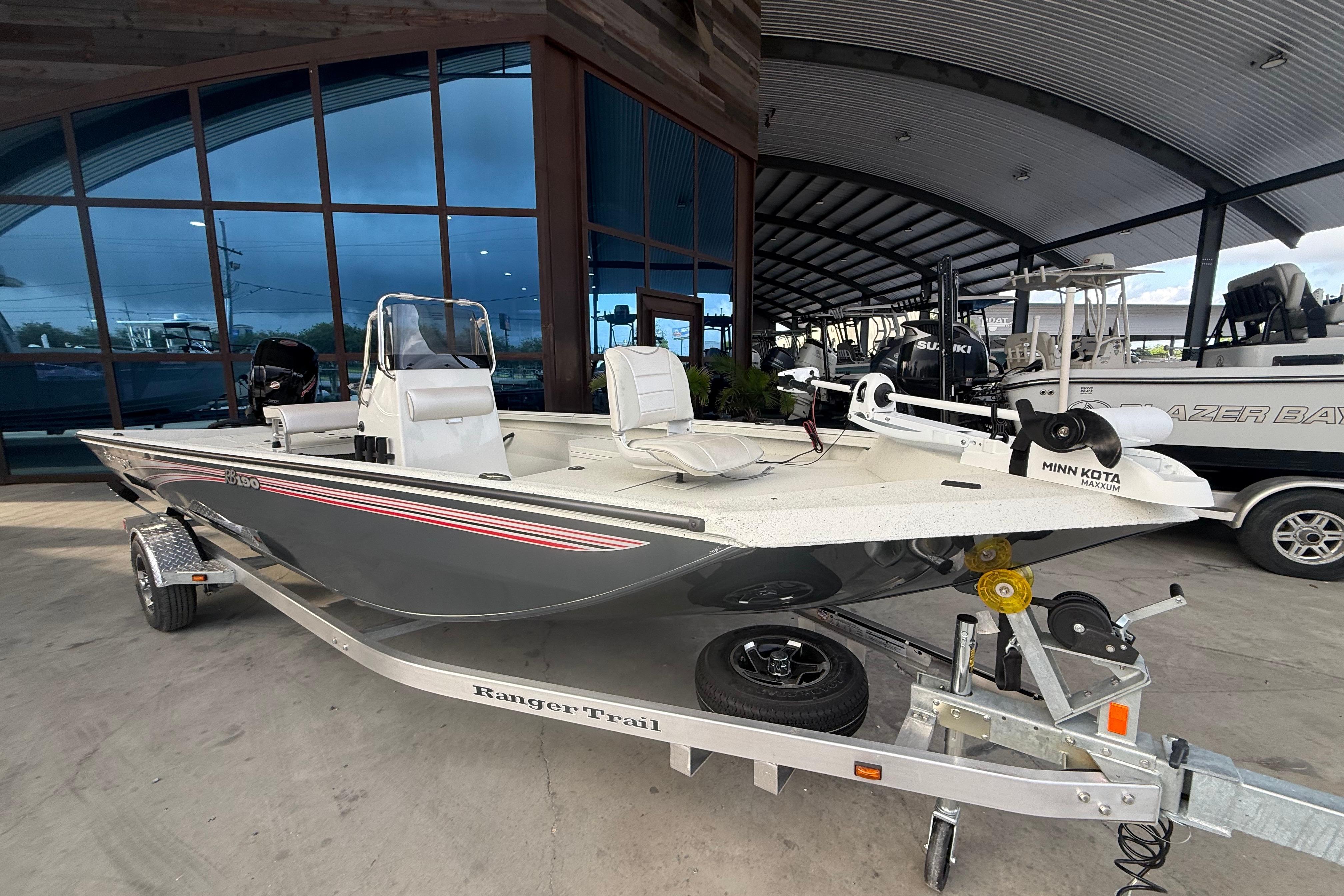 2026 Ranger RB190 boat on trailer, displayed in a showroom with modern architecture.