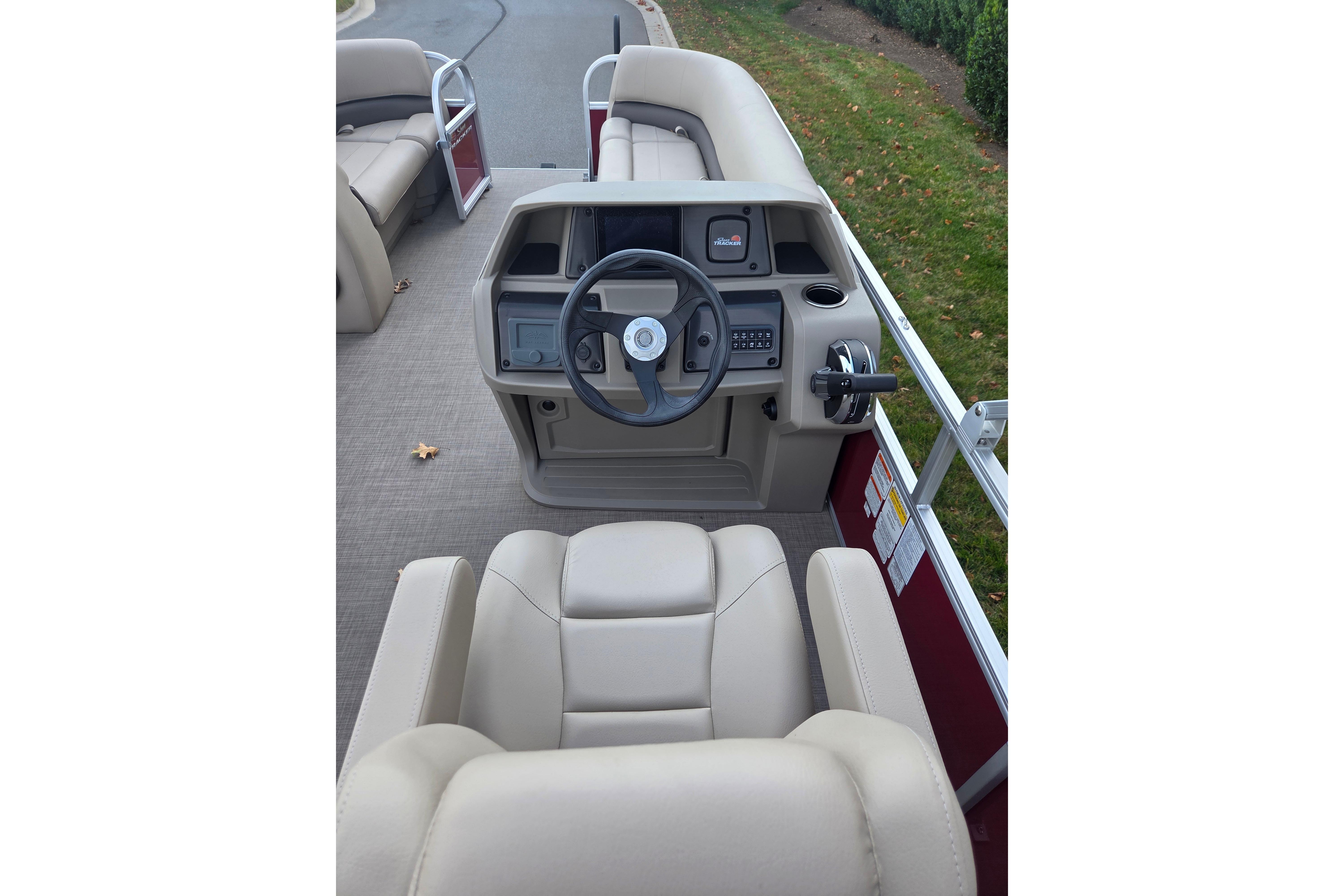 2025 Sun Tracker Party Barge 18 DLX interior with steering console and seating.