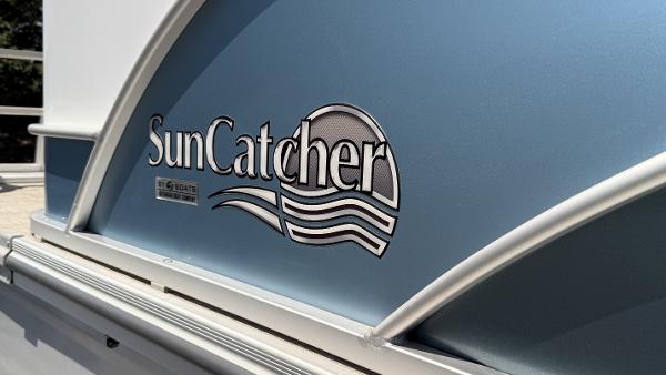 2023 SunCatcher Select 322FC logo on a blue boat panel.