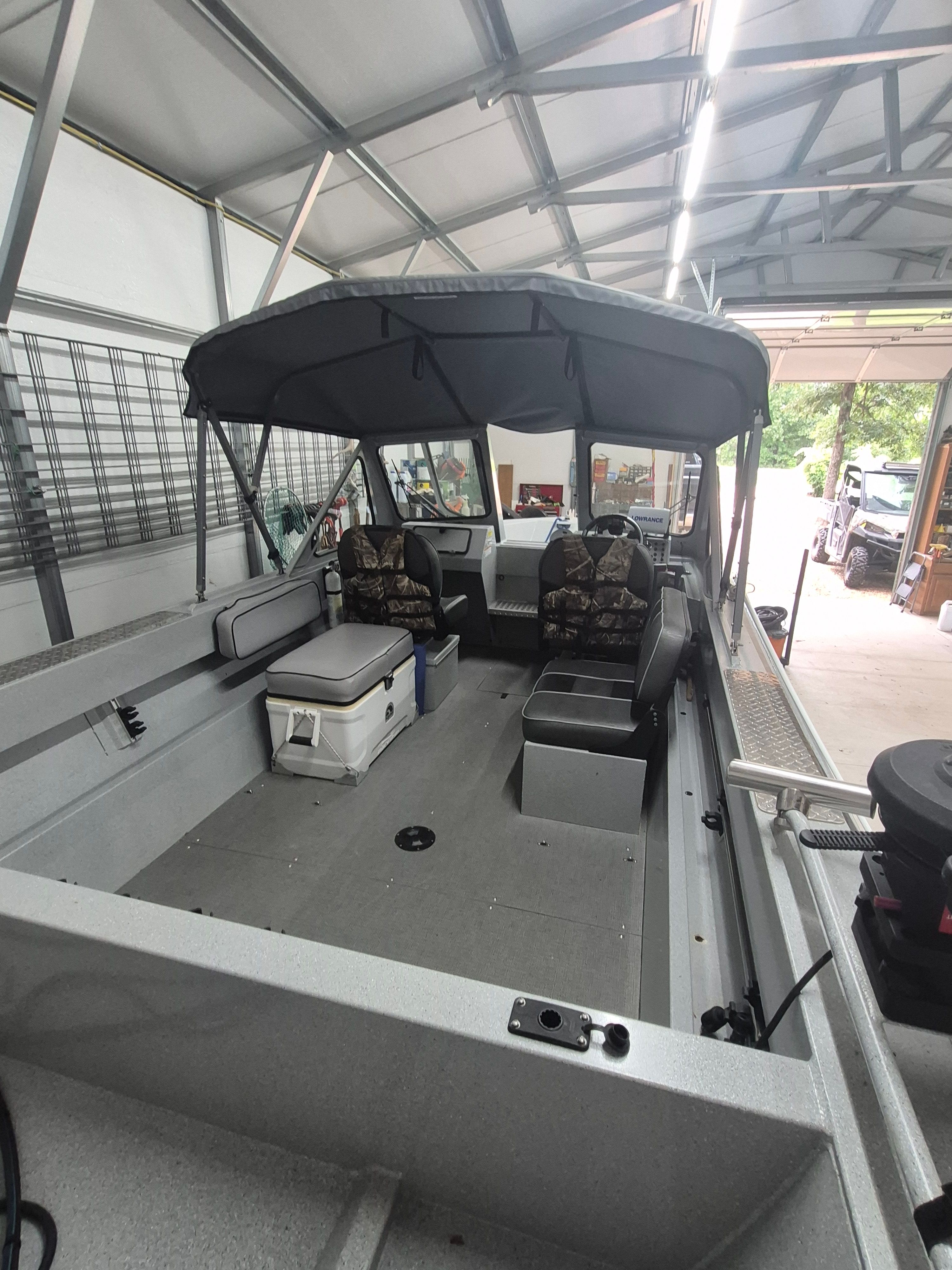 Interior view of a 2016 Duckworth 18 Advantage boat in a garage.